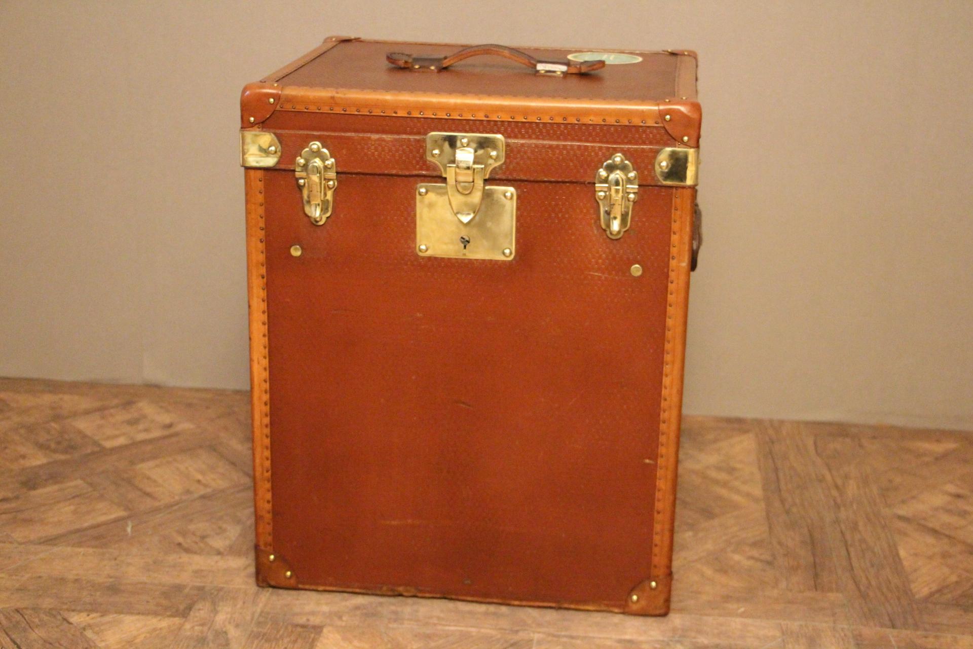 Beautiful tall hat box with solid brass locks and leather handles on each side as well as on the top. A couple of traveling labels.
It is an unusual shape because it is tall.
Original inside with its removable tray. Only the interior of the lid
