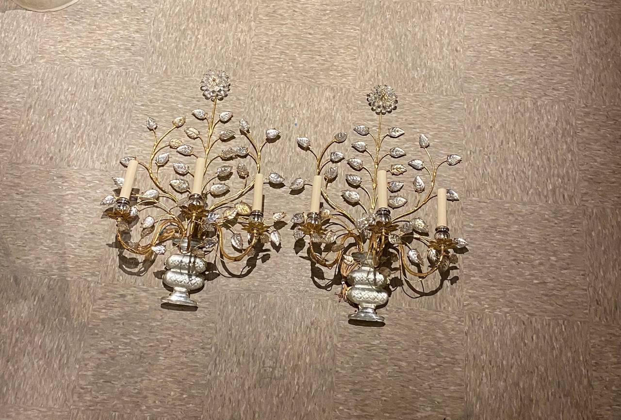 A pair of circa 1930’s gilt metal 3 lights sconces with crystal leaves and flowers