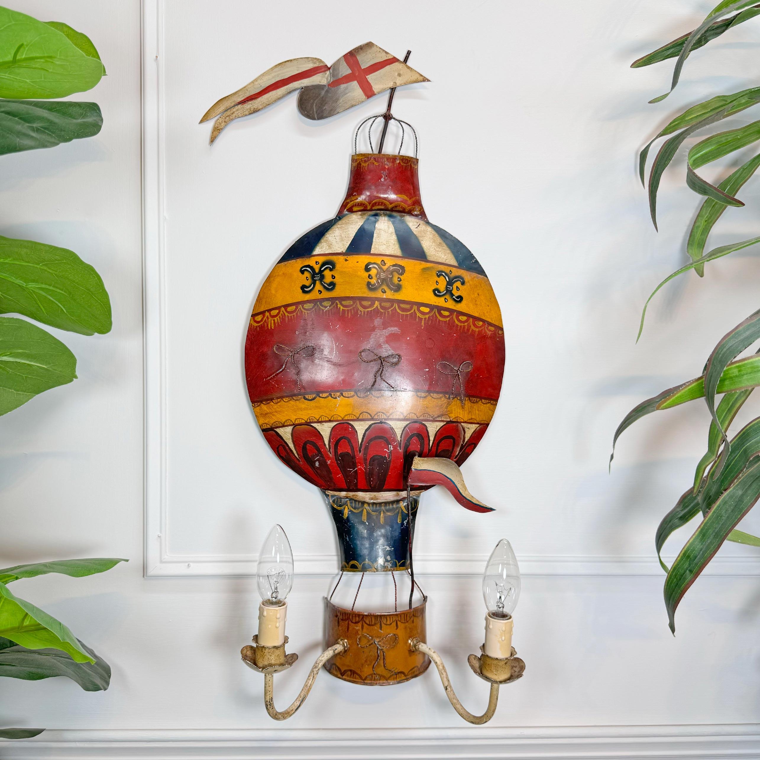 A stunning, colourful 1930's French tole Montgolfiere (hot air balloon) wall sconce.



This stunning light is a very rare find in such great original condition



The main balloon body of the light is in full metal with original hand painted