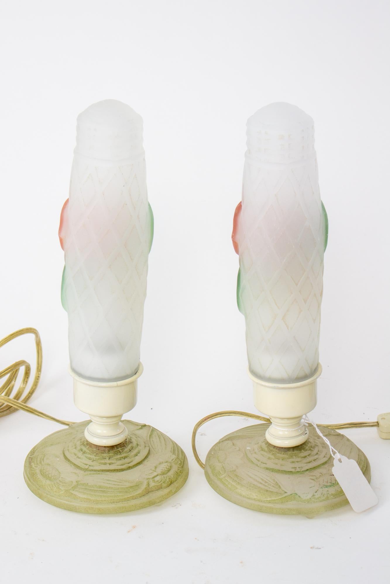 Frosted glass floral boudoir lamps, a Pair. Frosted glass bases and shades. Light bulb is enclosed for soft light. Painted red and yellow flowers. Glass shades have a basketweave texture. Designed to provide soft light on a vanity or boudoir table.
