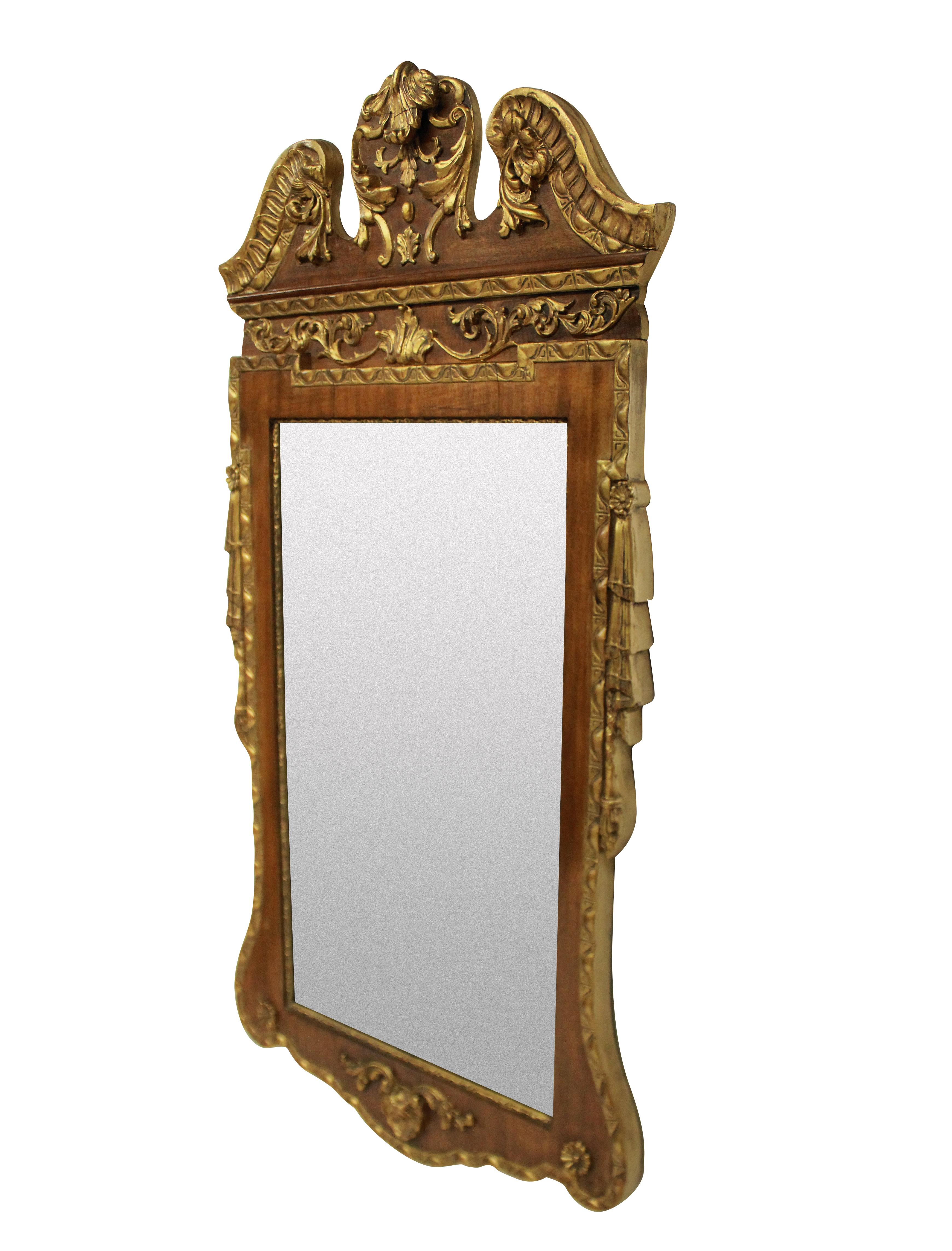 An English George II style carved walnut and gilded mirror.
