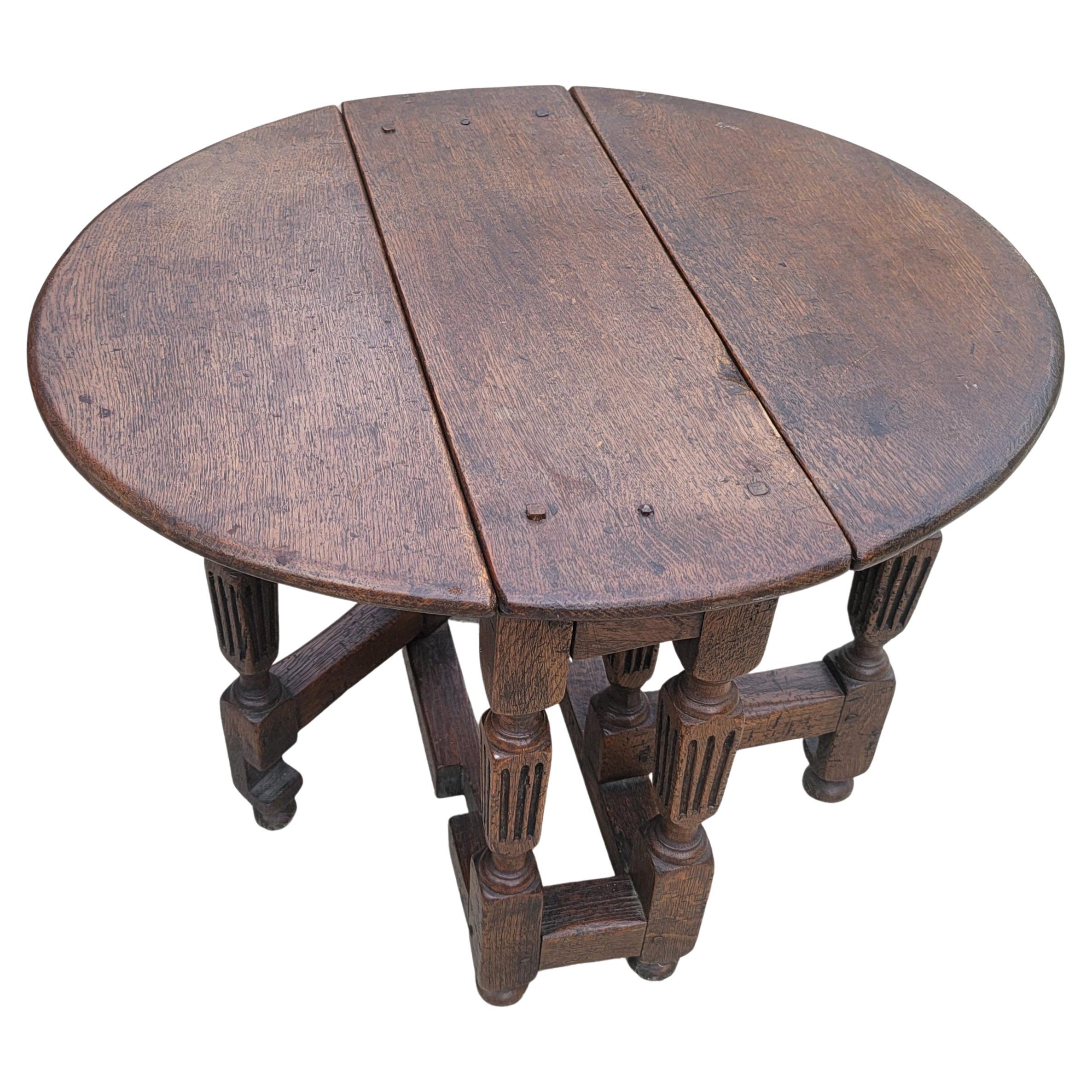 George III Style Oak Diminutive Drop-Leaf Gate-Leg table. Use it as small center table,or as a side table. This table is made off of 100% solid oak. Measures 23.5