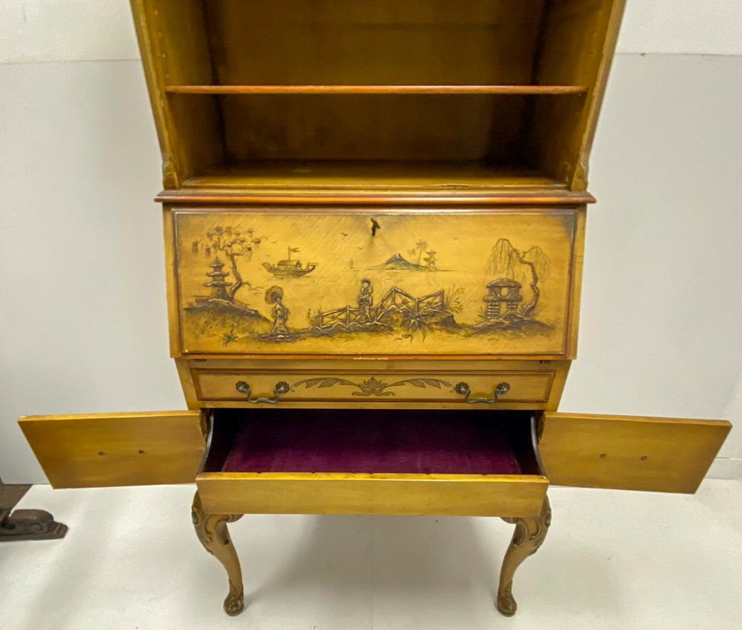 This is a 1930s Georgian style painted chinoiserie secretary desk with open bookcase top. It is predomently gold and red. It does include the key, and the piece is unmarked. The bottom section is two doors that open to reveal a drawer. Knee