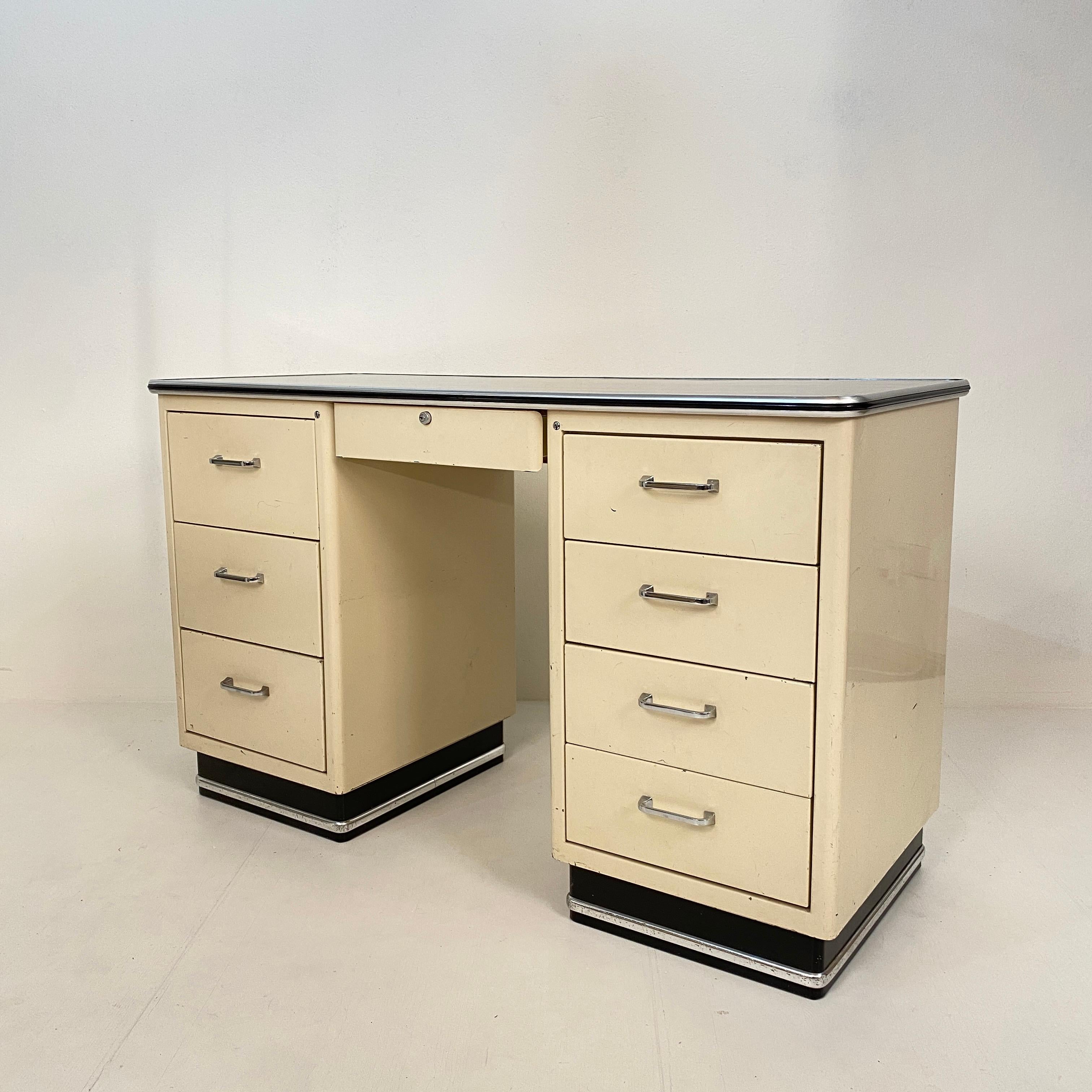 This beautiful 1930s German Bauhaus desk is in its original condition and come directly from the first owner. It was standing in the doctor's office.
It is made out of white lacquered metal, chrome and has got a black linoleum top.
It is in a very