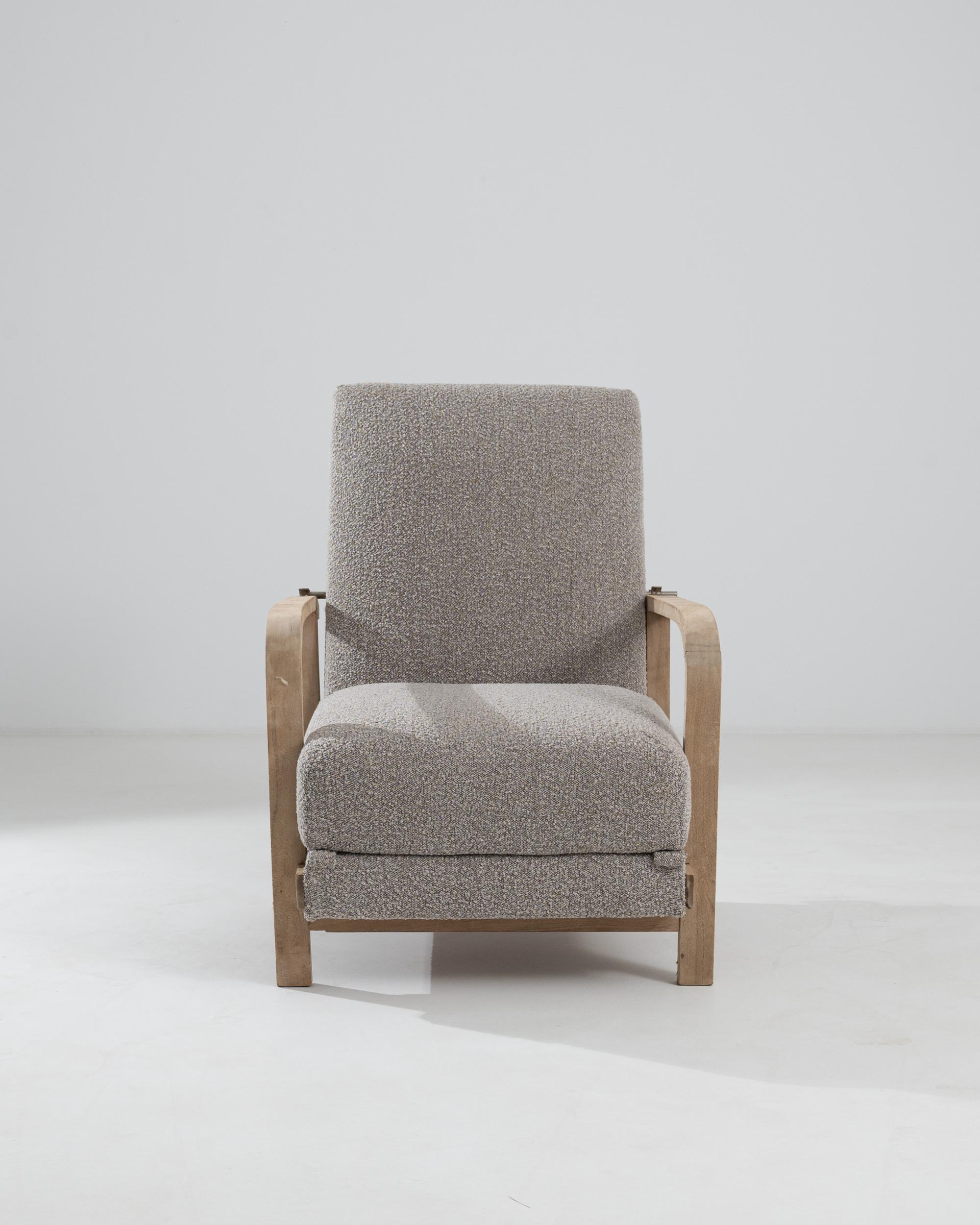 Serene and composed, this vintage armchair offers an irresistibly comfortable seat. Made in Germay in the 1930s, the design takes a Modernist approach, combining a clean shape with soft curves for an organic feel. The pale ash-blonde wood of the