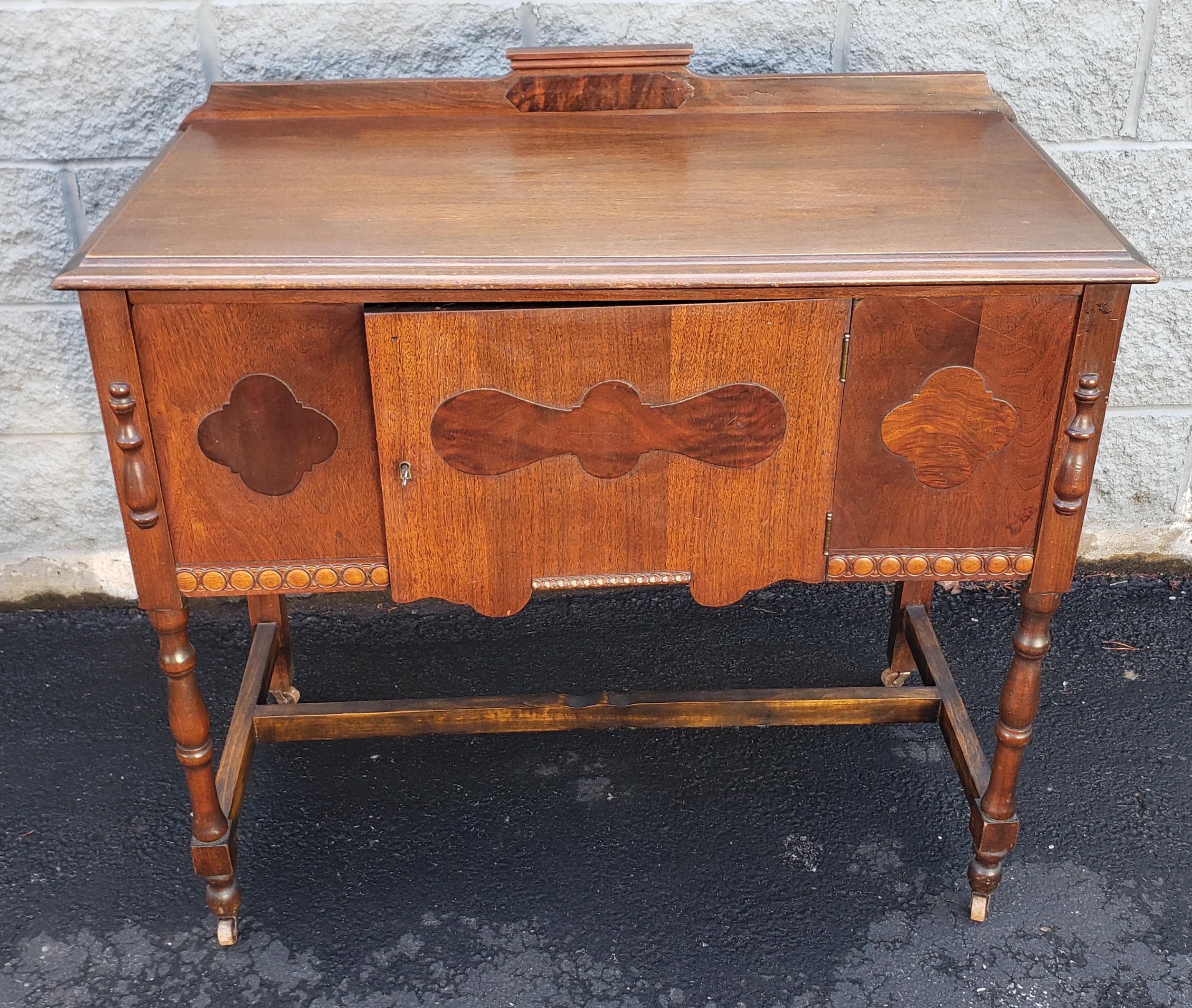 A gorgeous 1930s Art Deco rolling mahogany credenza buffet server by the famous Gettysburg Furniture Co.
Great vintage condition. Unbeliebly light weight on original wheels. Original Key present but really functional.
Measures: 38