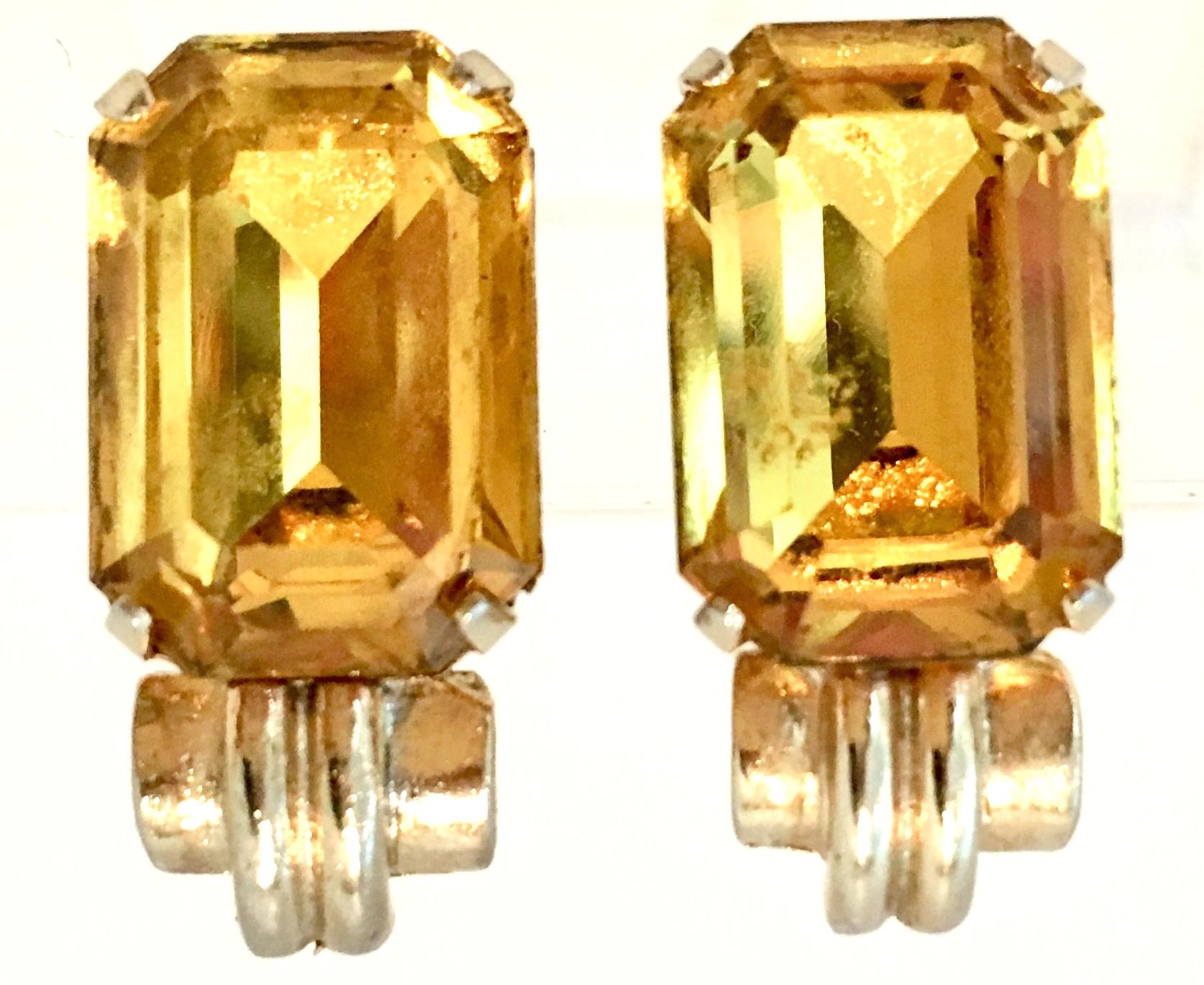 1930'S Gold Plate & Citrine Cut And Faceted Glass Earrings By, Coro. These rare and earlier pair of clip style brilliant cut citrine glass earrings feature a large prong set single emerald cut center stone. The center stone measures approximately,