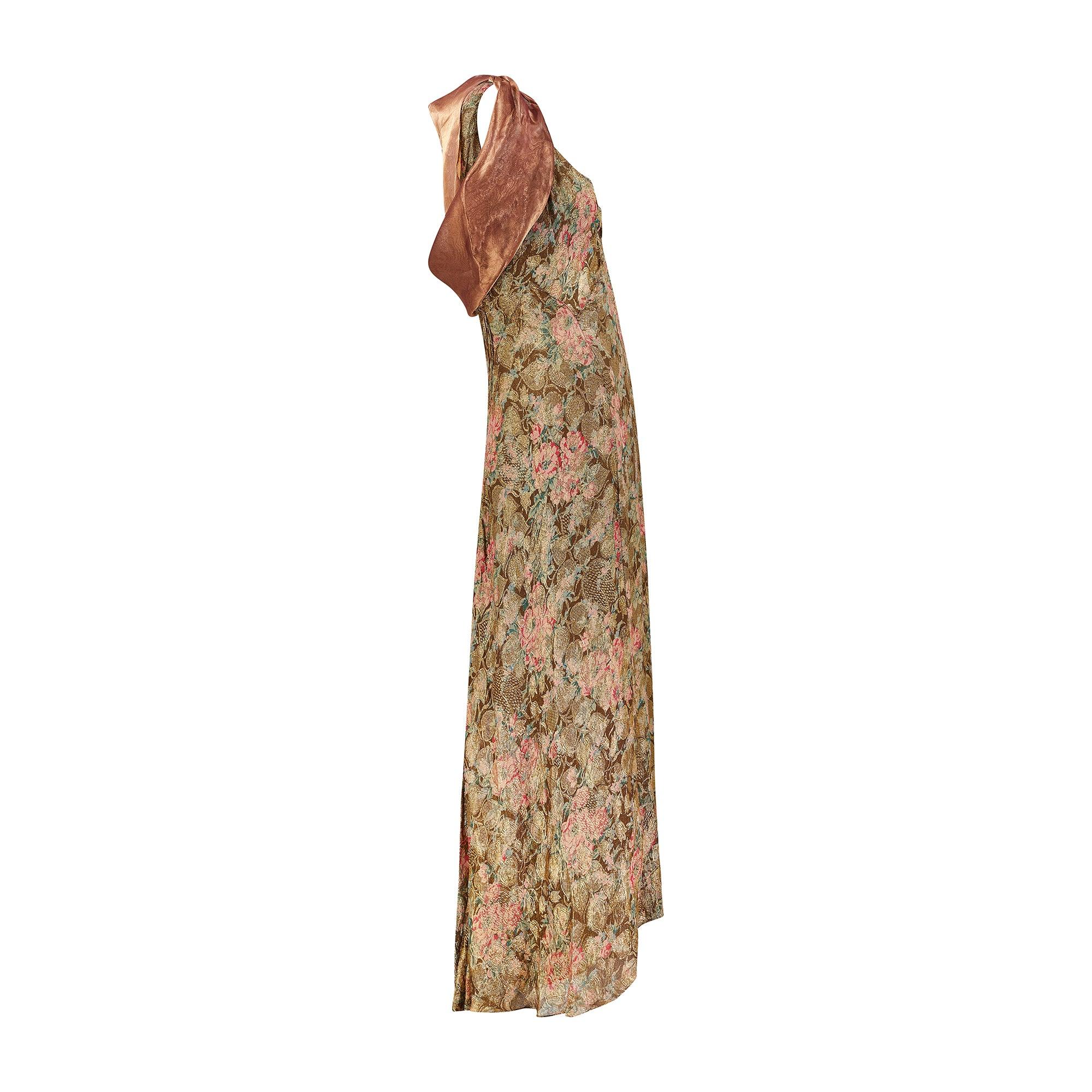 1930s gold and floral lame dress with contemporary custom-made capelet.  Of an ankle skimming length, this piece is crafted from the most incredible fabric; a glittering golden lamé detailed with paler gold textured leaves that appear to spin