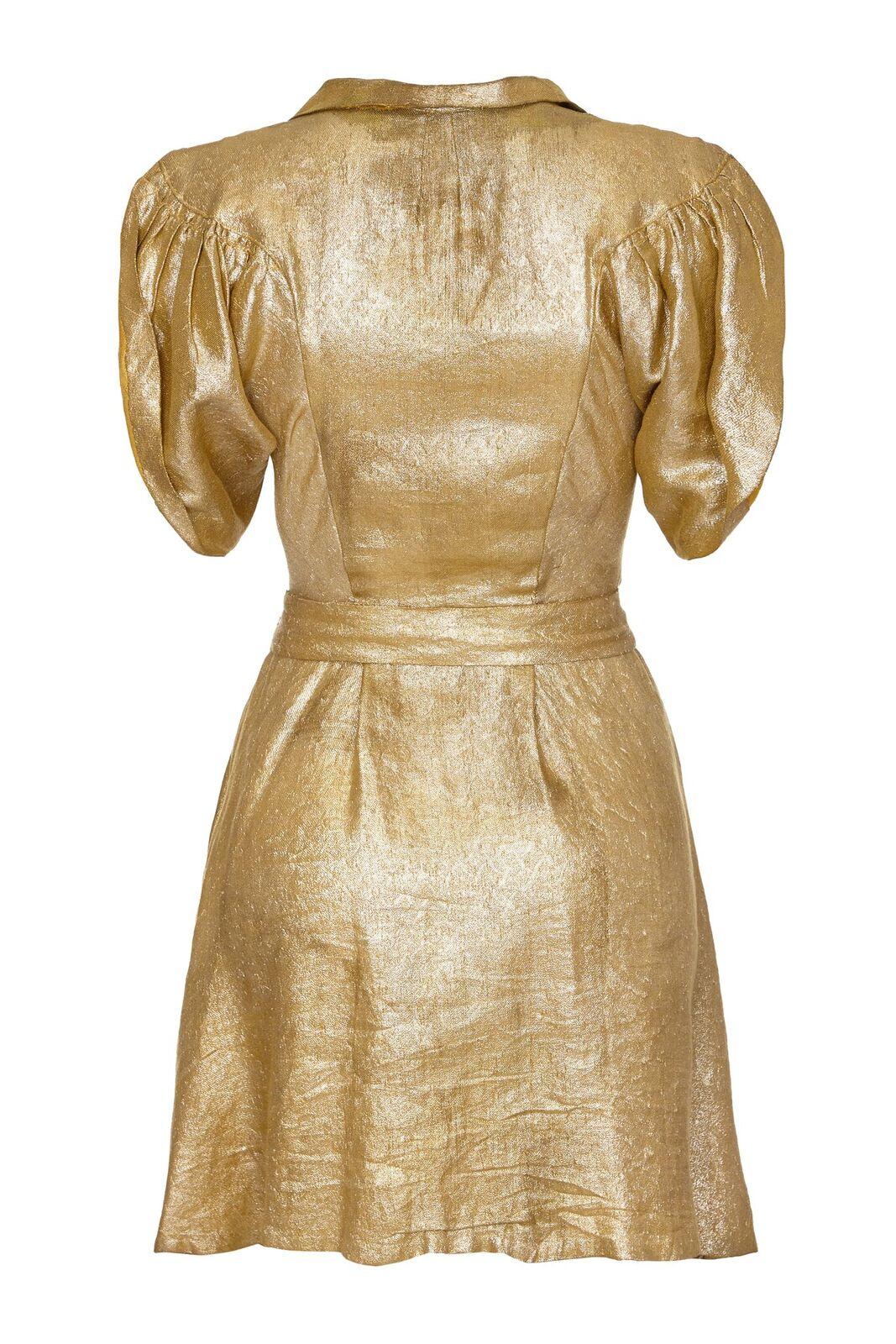 This incredible gold lame party dress, circa late 1930s, is undeniably modern for a piece of this era. The soft gold metallic fabric is beautifully tailored in the bodice with batwing style sleeves curving in towards a petit  and tidy waistline. The