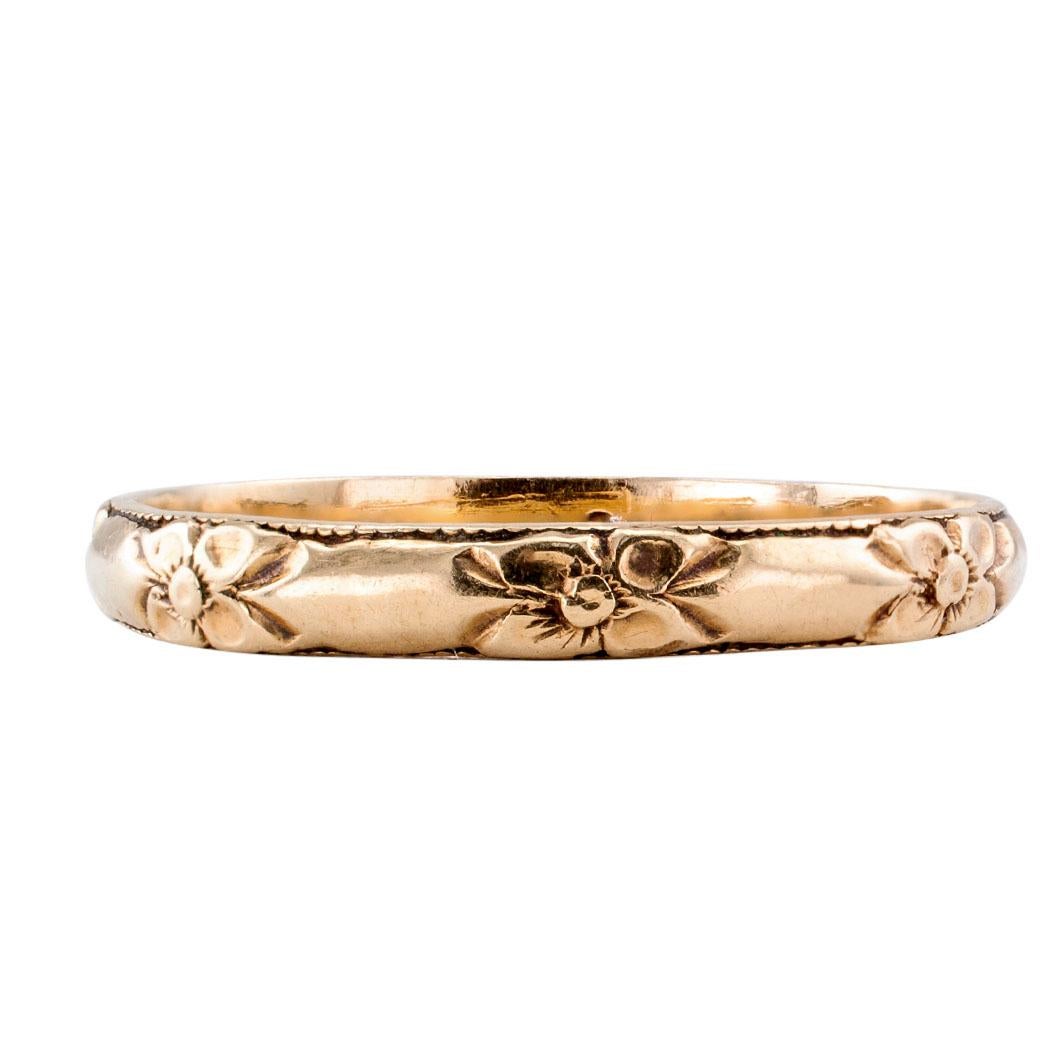 Vintage gold wedding band size 13 circa 1930. Crafted in 14-karat yellow gold, 3 mm wide, decorated by a floral motif, repeating at intervals throughout, signed inside the shank Lohengrin. According to record, Lohengrin was an American jewelry