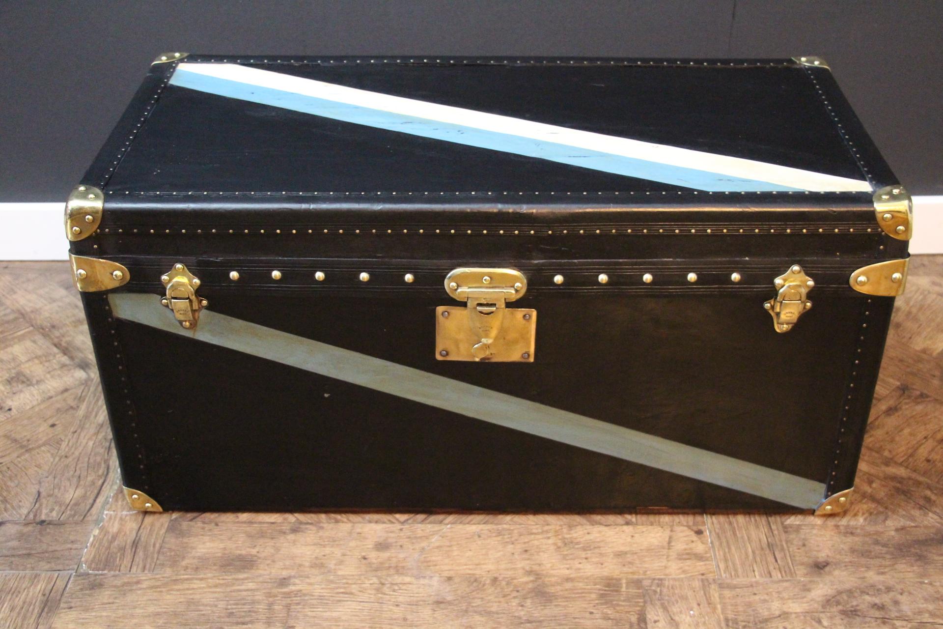 This magnificent Goyard steamer trunk features the very unusual black canvas, Goyard stamped solid brass lock and latches, as well as brass studs and large leather side handles.. It also has a very deep black lozine trim. Its patina is beautiful and