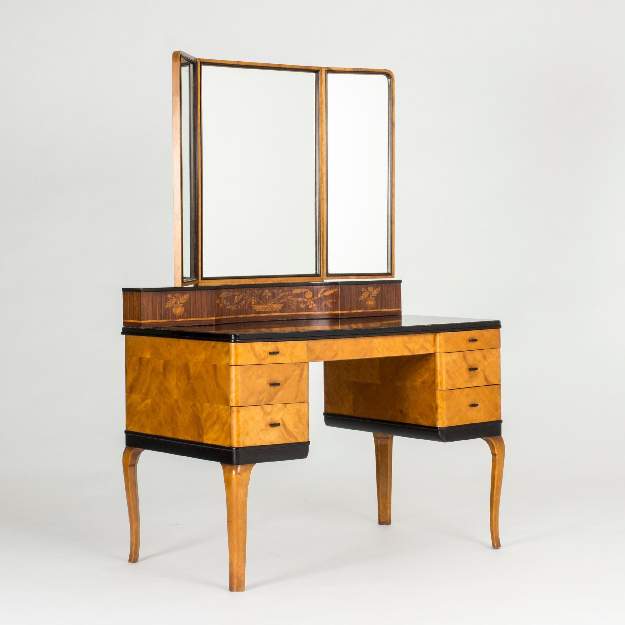 Beautiful “Haga” dressing table by Carl Malmsten. Birch veneer contrasts with the black lacquered table top and the decorative darker wood with inlays under the mirrors. Functionalism with an elegant touch of rokoko.