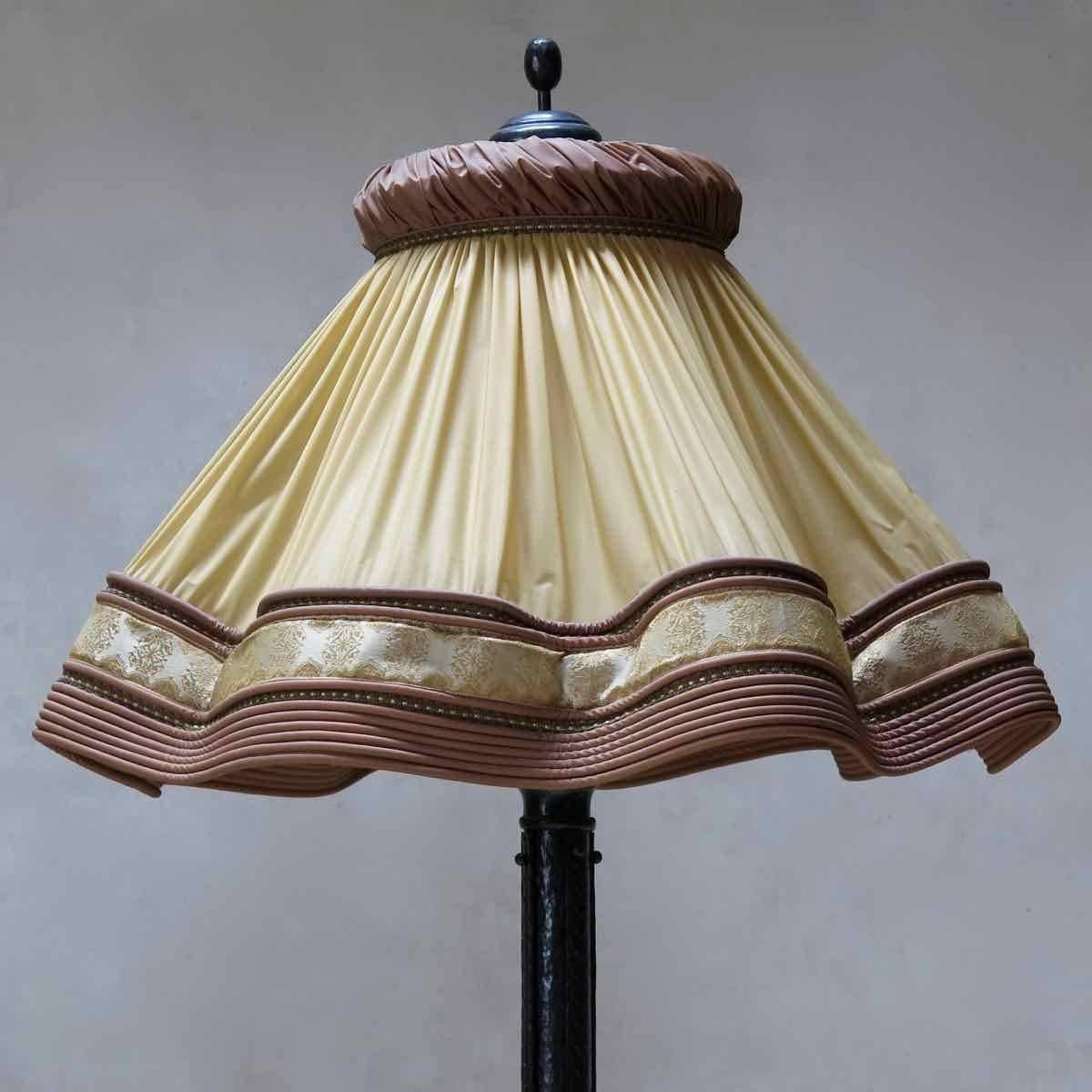 Large and imposing hammered-iron floor lamp, of elegant and unusual design. Fitted with a wonderfully kitsch, large, plissé plastic lampshade, meant to imitate silk!