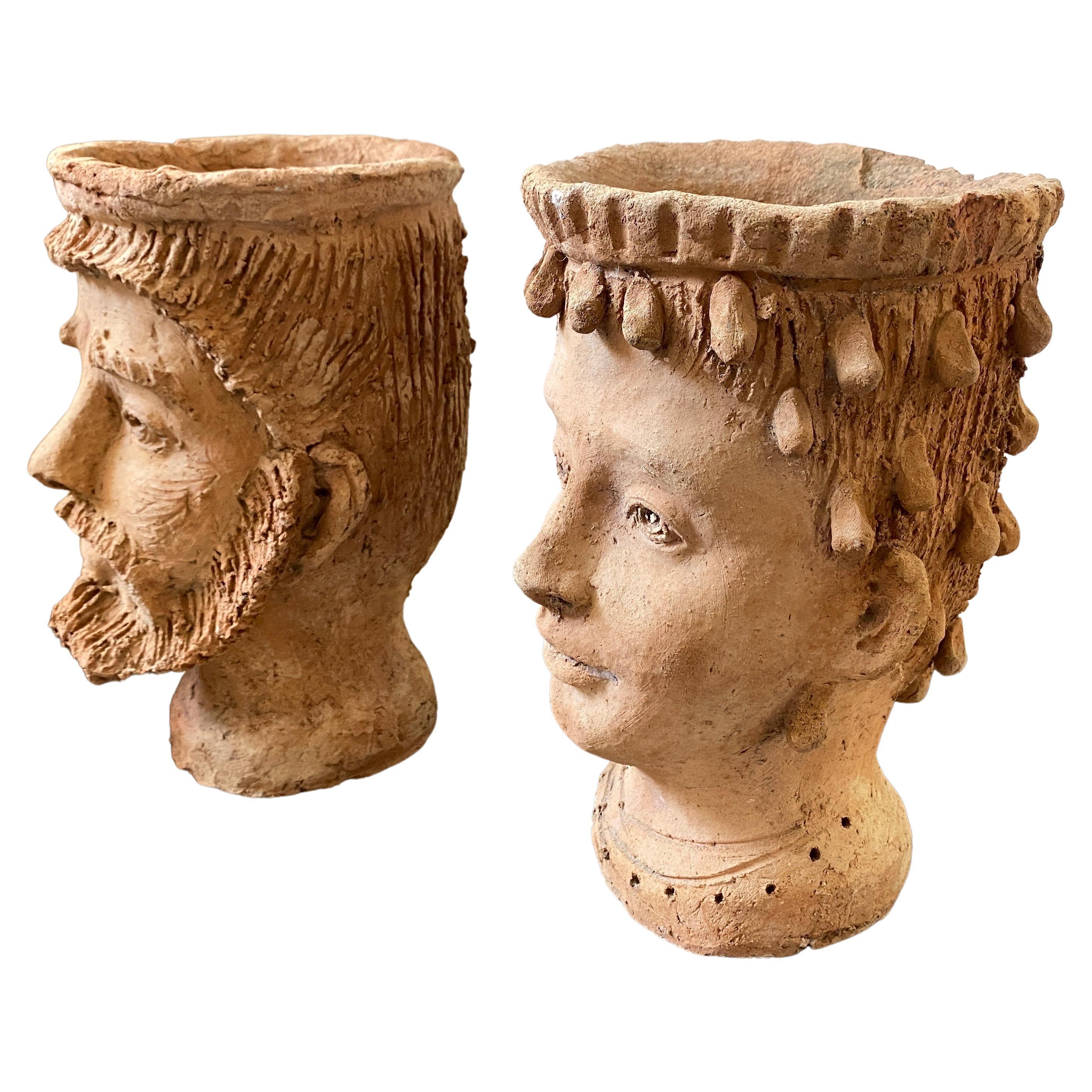 Two terracotta vases hand-crafted in Caltagirone, world famous town Sicilian ceramics. They are in original vintage conditions, The Moro Heads are a symbol for Sicily, but they have a very ancient and important history behind them. A legend made of