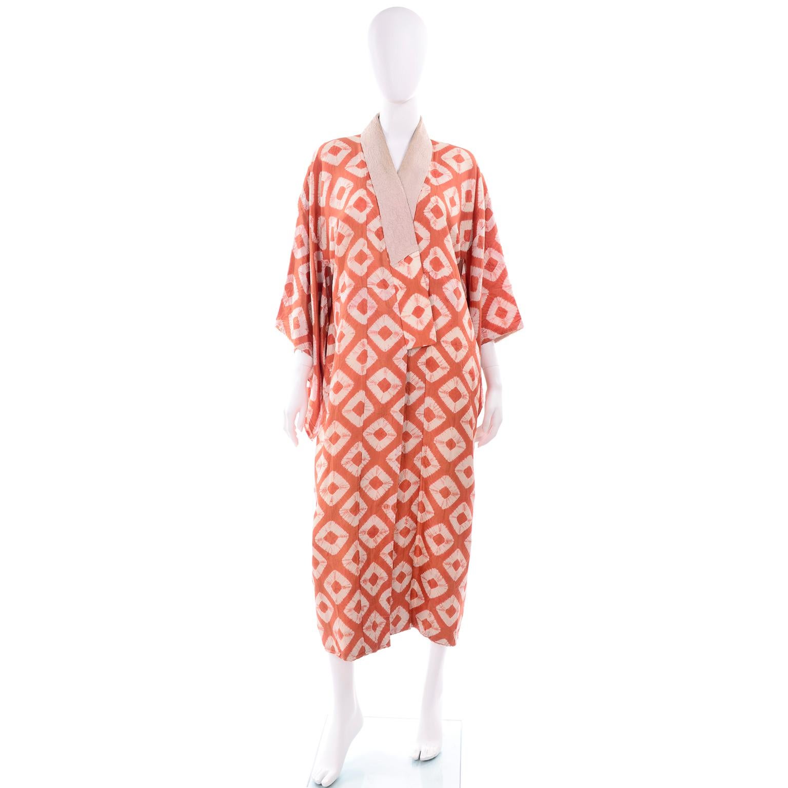 We love Japanese kimonos and this one is so lovely in an orange and cream shibori silk geometric pattern and tan collar. This incredible kimono is hand dyed and can be worn with a belt as a coat or at home as a lounging robe.  The silk is ultra fine