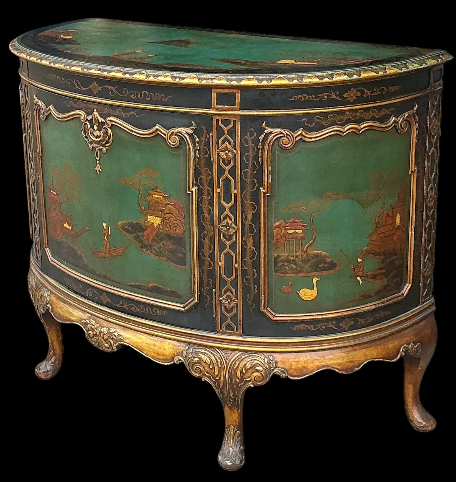 This is a lovely early twentieth century Chinese Chippendale chinoiserie cabinet. The green and black paint combined with the gilt fretwork are a striking combination. The cabinet opens to a single shelf. It has non-offensive general wear. The