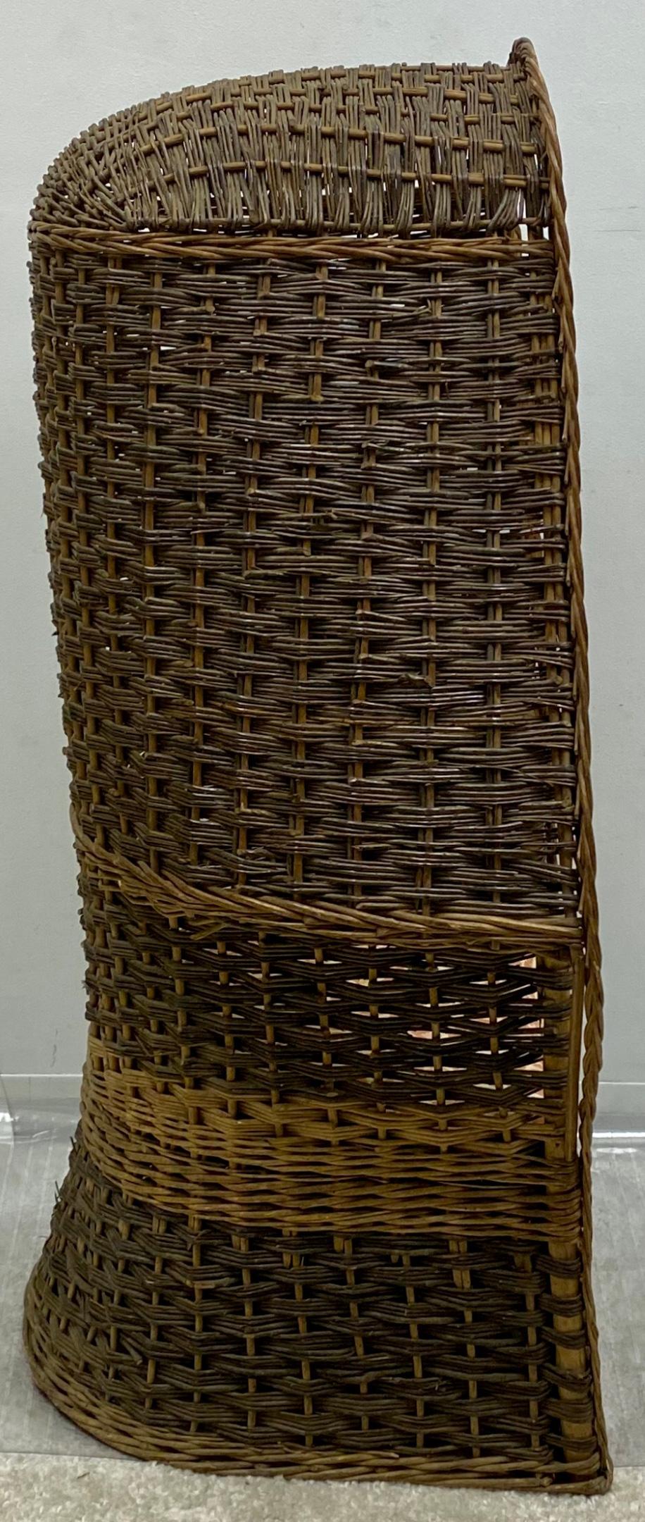 This is a 1930s hand woven wicker porter’s chair. It is a two tone weave and is in very good condition. An unusual find!