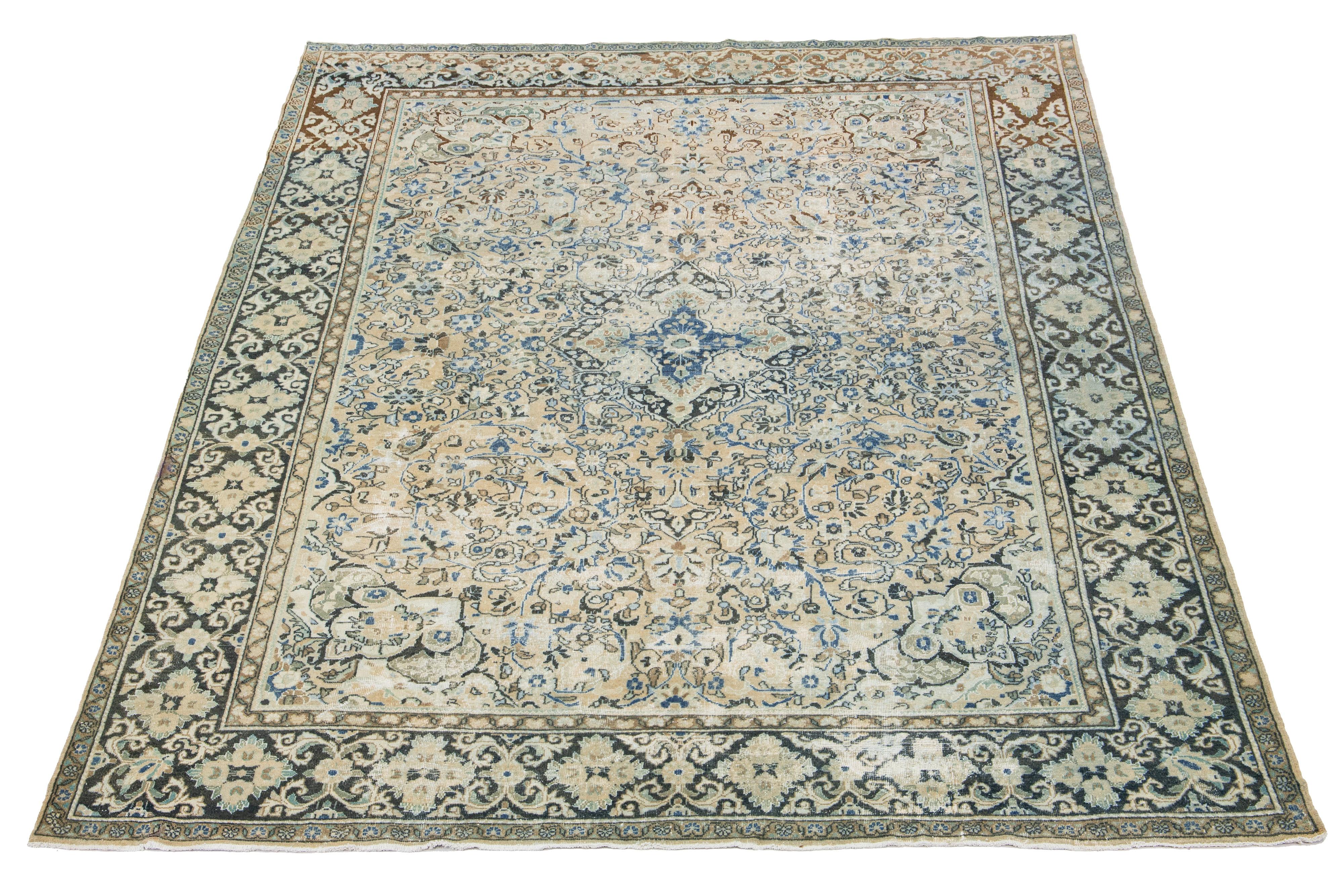 Beautiful Antique Mahal hand-knotted wool rug with a beige-colored field. The floral motif of this Persian rug is adorned with blue and brown hues.

This rug measures 9'10