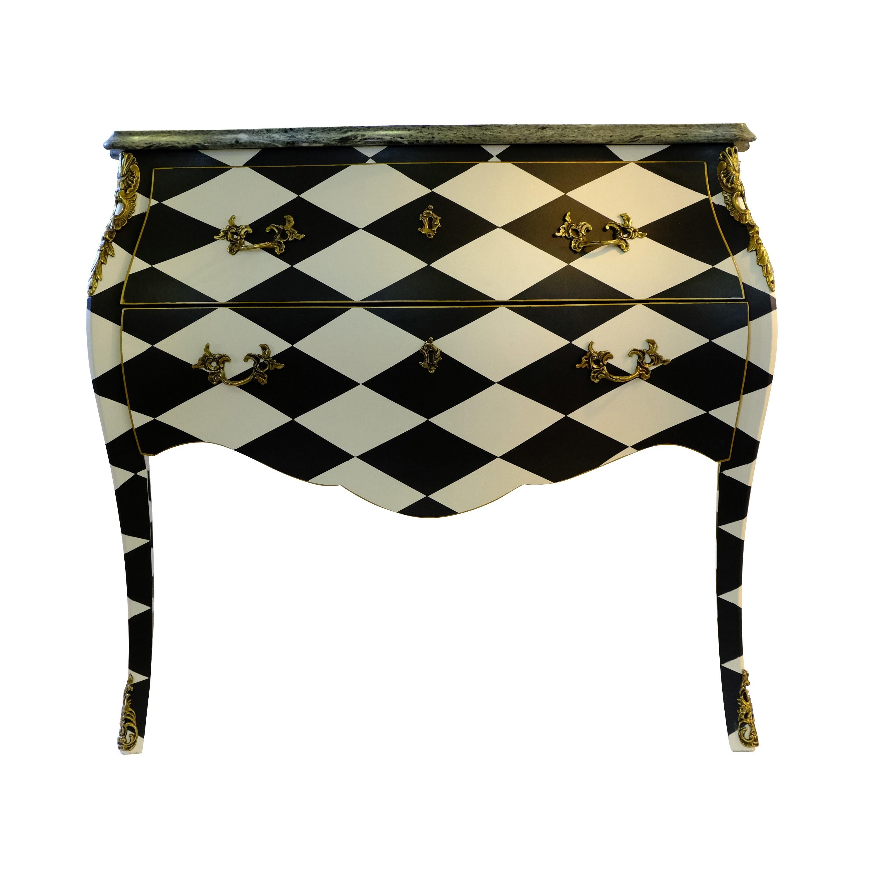 A Louis XV style commode from the early 19th century renovated to the highest standard with a harlequin pattern. Original cast brass metal fittings and marble top. 2 drawers. 
Measures: Width: 83cm / 32.7
