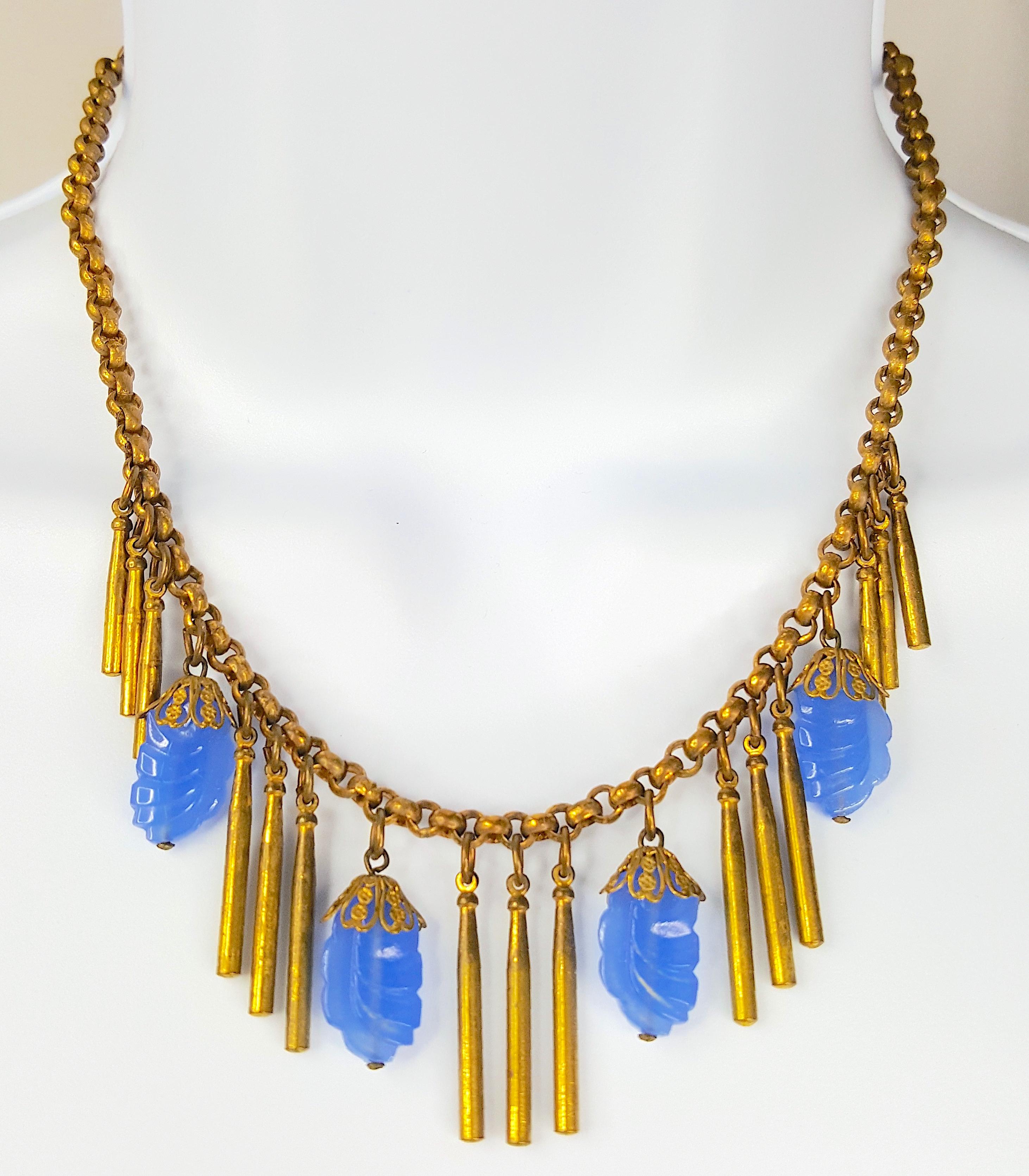 Featuring a relatively heavy fringe of dangling Russian-gilt brass bars and contrasting French-blue textural hand-pressed glass beads topped with filigree caps to resemble flower buds, this c.1930 brass round-link chain necklace was made in an Art