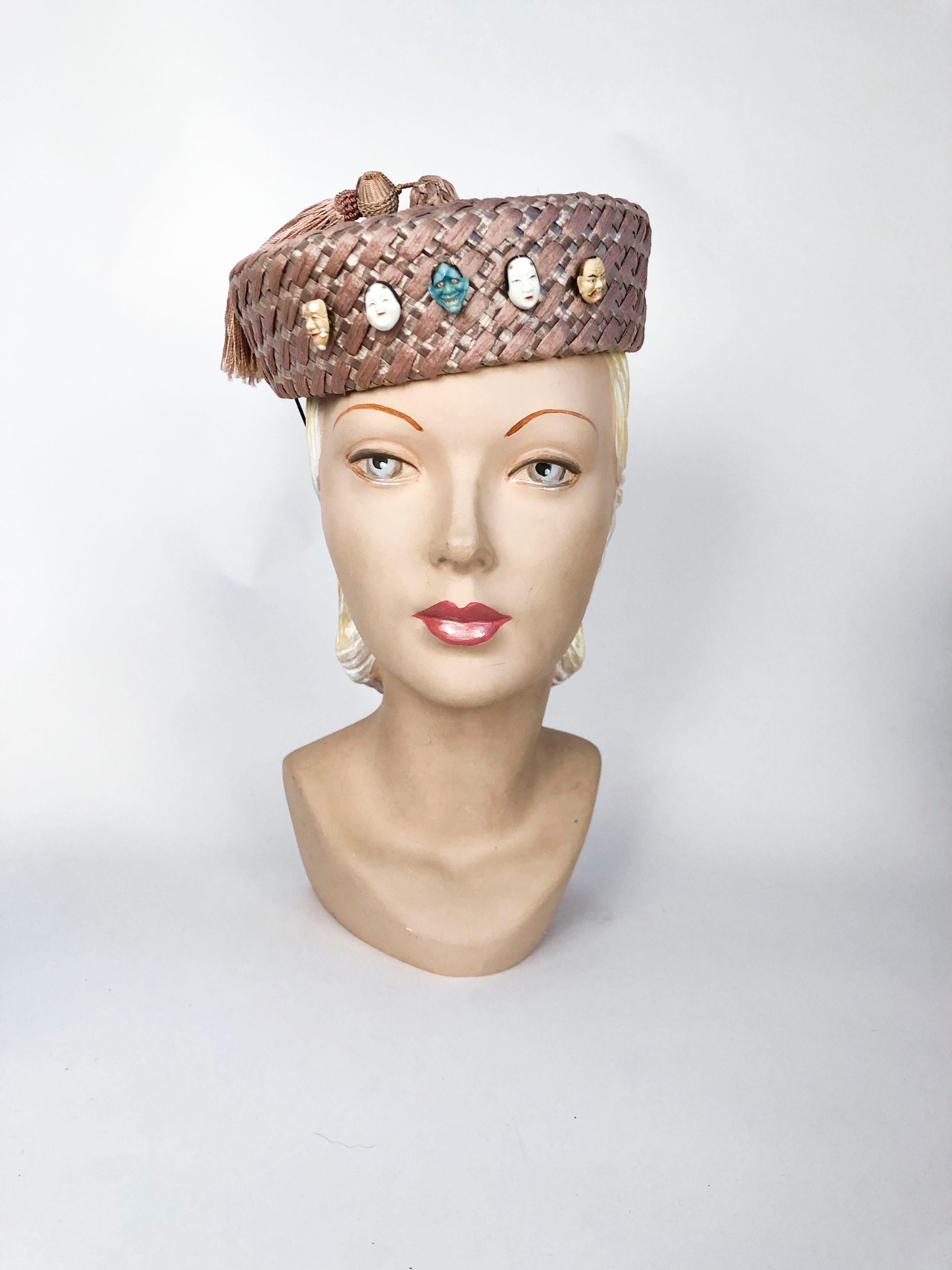 1930's Hattie Carnegie Mauve Straw Hat with Opera Mask Buttons made of porcelain and a matching tassel. . 