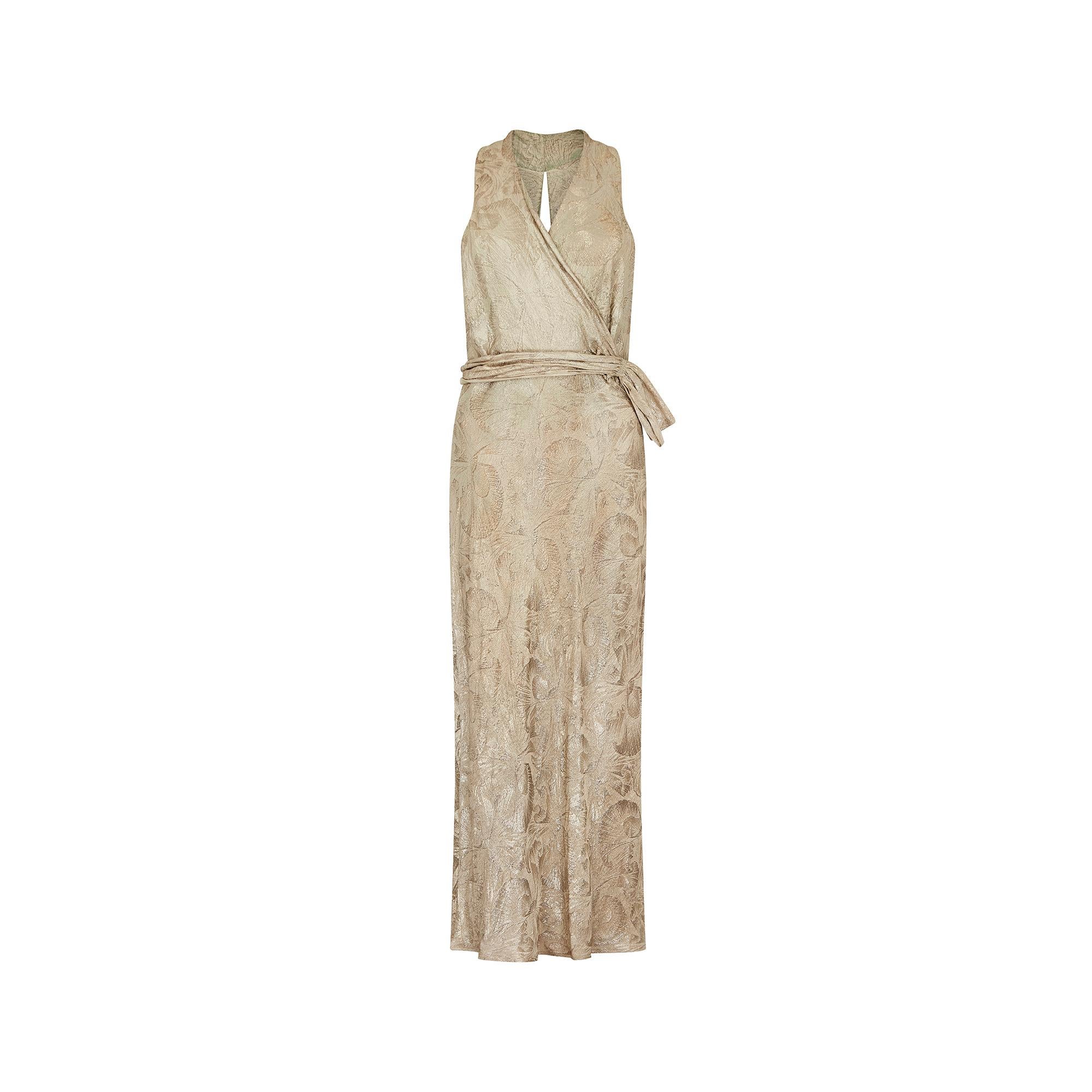 Original 1930s haute couture gold lame evening dress, in fabulous condition for its age.  It features a crossover front with tie waist detail, and a keyhole cutout back. The fabric is a stunning burnished gold lame, almost champagne in colour, with