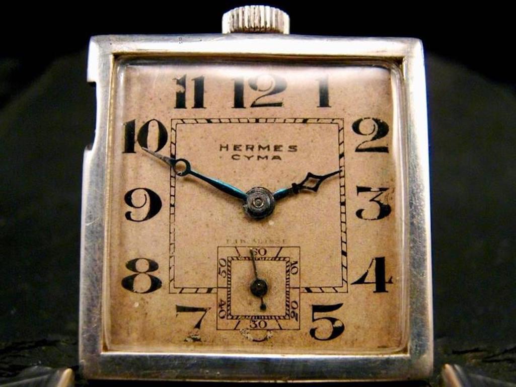 Rare Hermes belt buckle watch from the 1930s. Silver case with Arabic numerals and smaller inset second clock. Made for golfers so that they could look down and check the time without wearing a watch. Looks great closed and then flips open. Made in