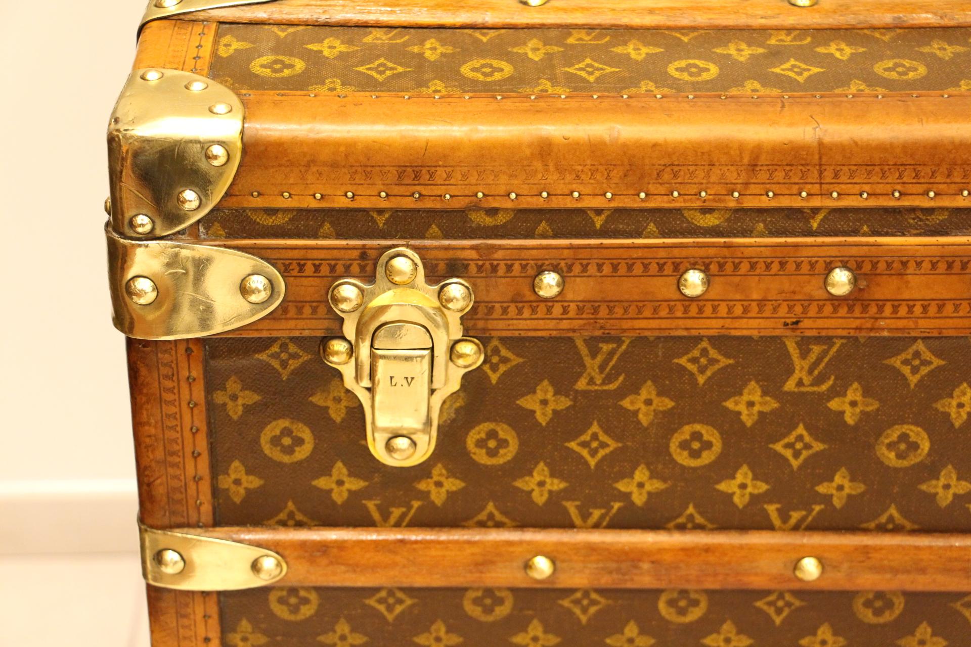 Unusual high Louis Vuitton steamer trunk featuring stenciled monogram canvas, honey color trim, stamped LV solid brass lock and clasps, brass corners and stamped LV studs. It has got a beautiful and warm patina. Leather side handles.
Original