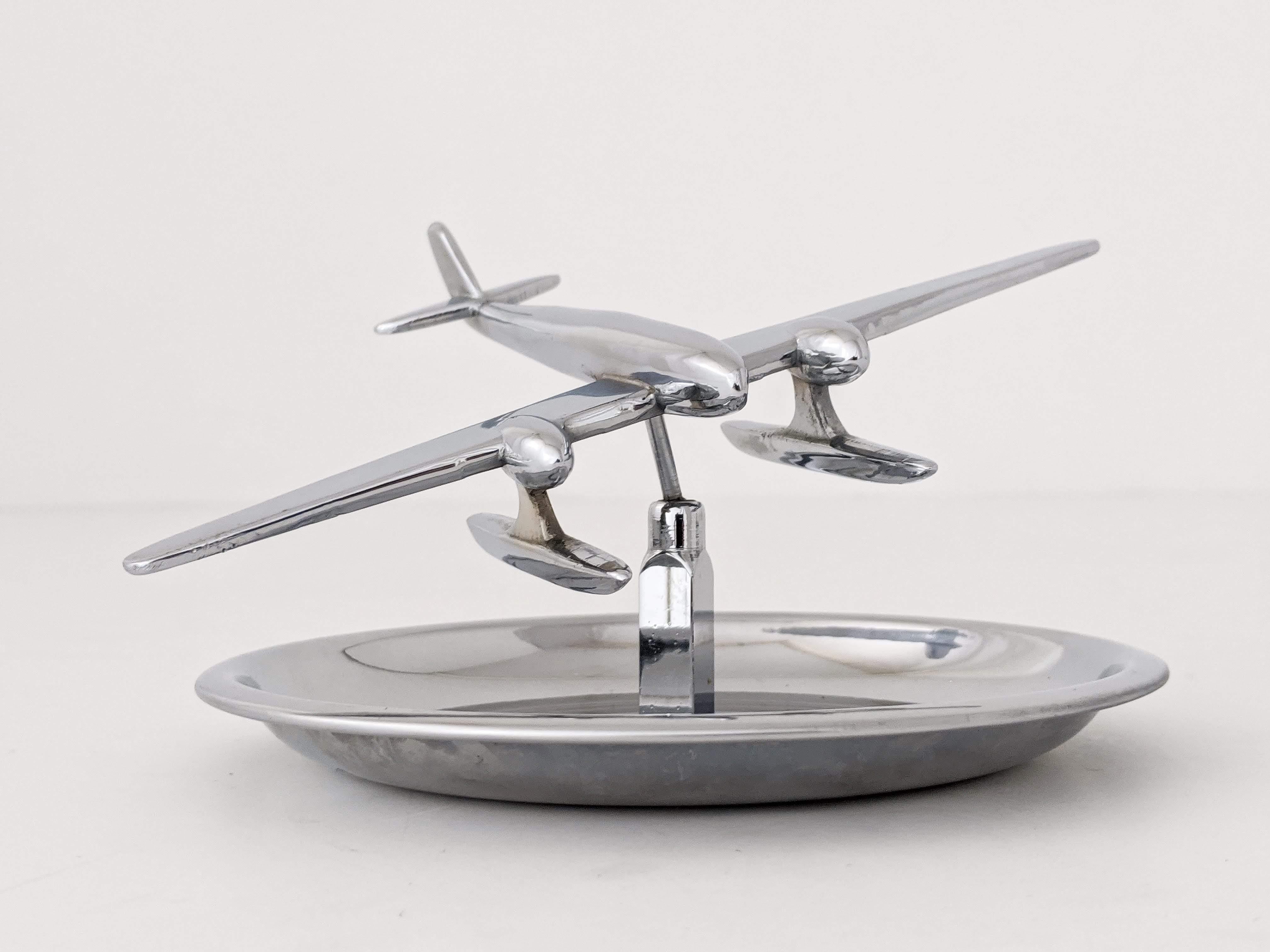 Art deco float/sea/hydro plane vide poche or empty pocket tray made of chromed brass. 

Plane pivot in all direction. 

Measures: 6.5 in. wide by 2.5 in. high.