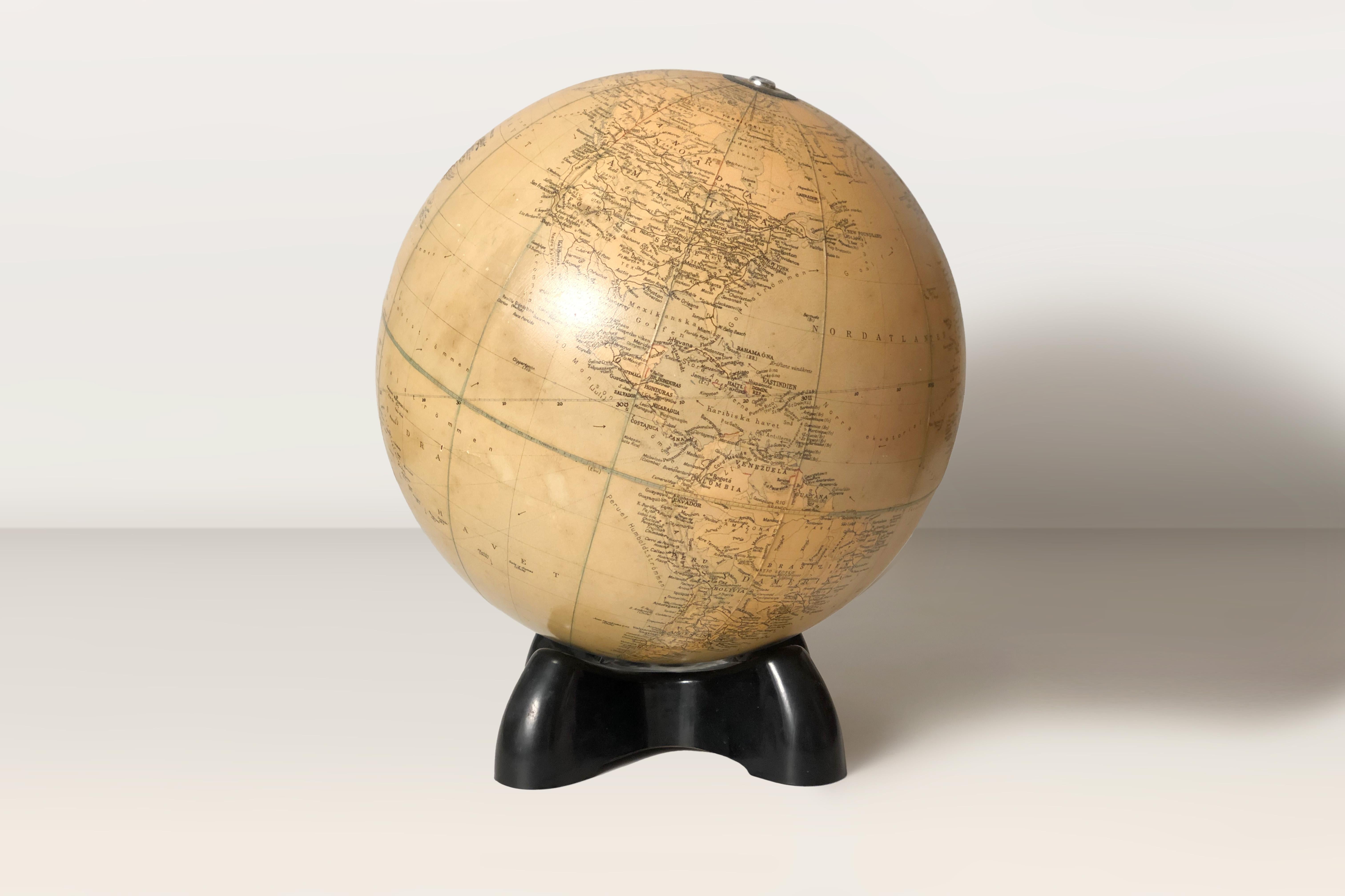 1930’s illuminated Art Deco terrestrial globe By Georama Ltd. London. Acrylic globe on a Bakelite base and a B14 light socket. Swedish edition with all names printed in Swedish. Circa 1