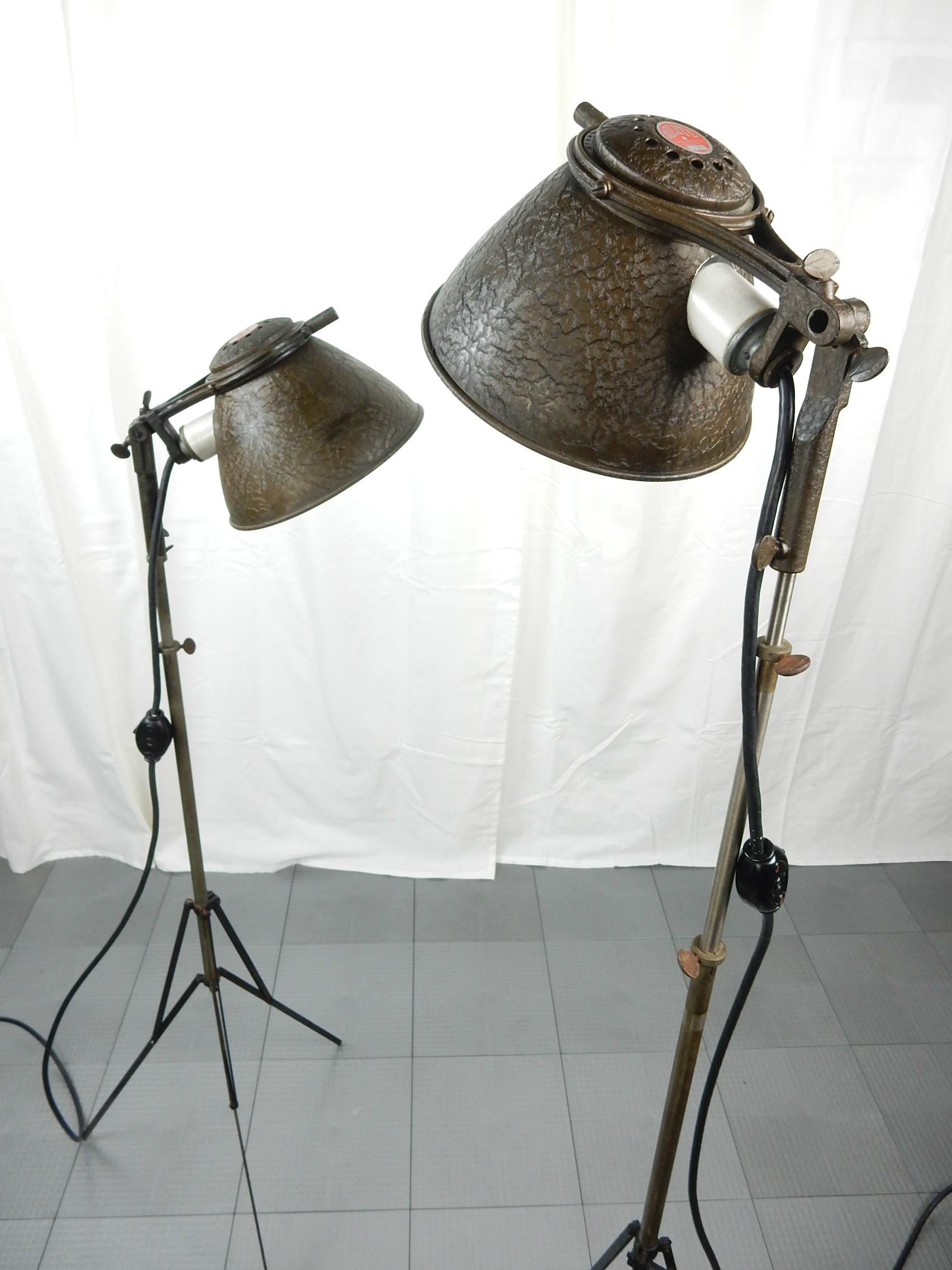 Pair of amazing 1930s Industrial spot floor lamps. 
Fully adjustable height and luminary direction. 
Each features wing nuts, alligator crackle finish on shades/arms, porcelain sockets and a large Bakelite GE switch on cord.
They adjust from