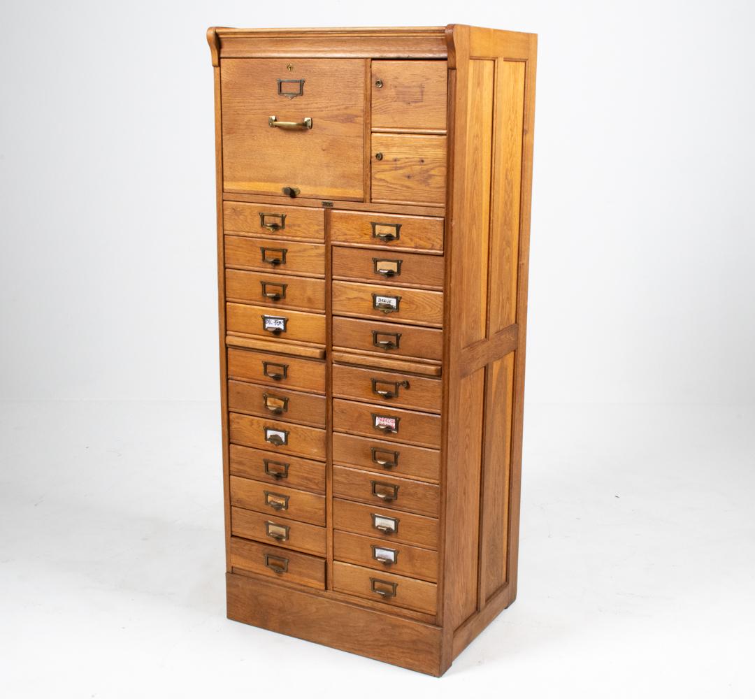 Add a dose of rustic utilitarianism to your home or make the most of your workspace with this unique file cabinet from the late Arts and Crafts period, produced by European maker S.M.V. in the 1930s. The storage includes three file drawers (one