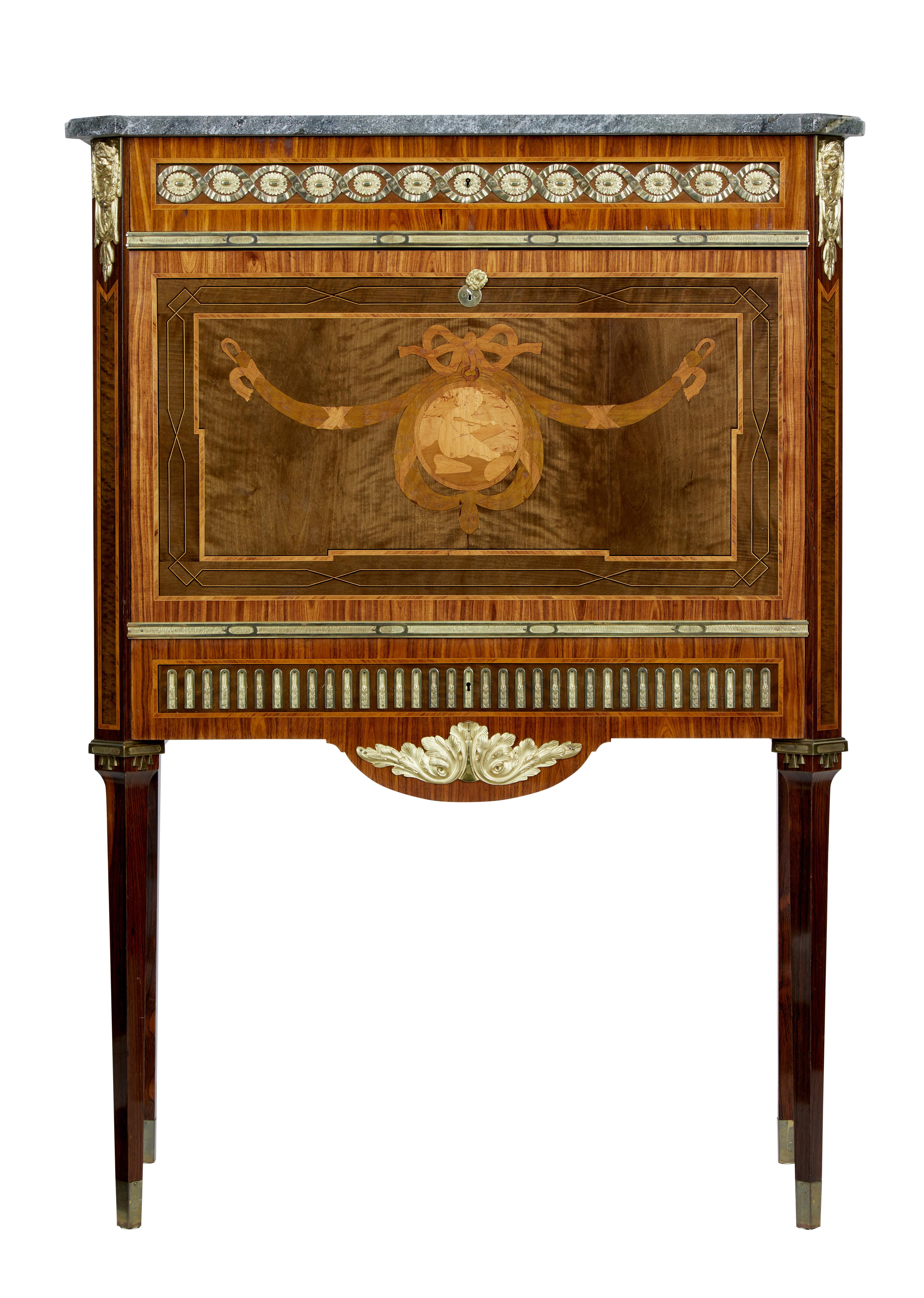 Good quality inlaid secretaire, circa 1930.

Over-sailing grey marble top with canted corners. Single drawer below the top surface cross banded and with ormolu mounts. Profusely inlaid fall drops down to a writing height of 28 3/4