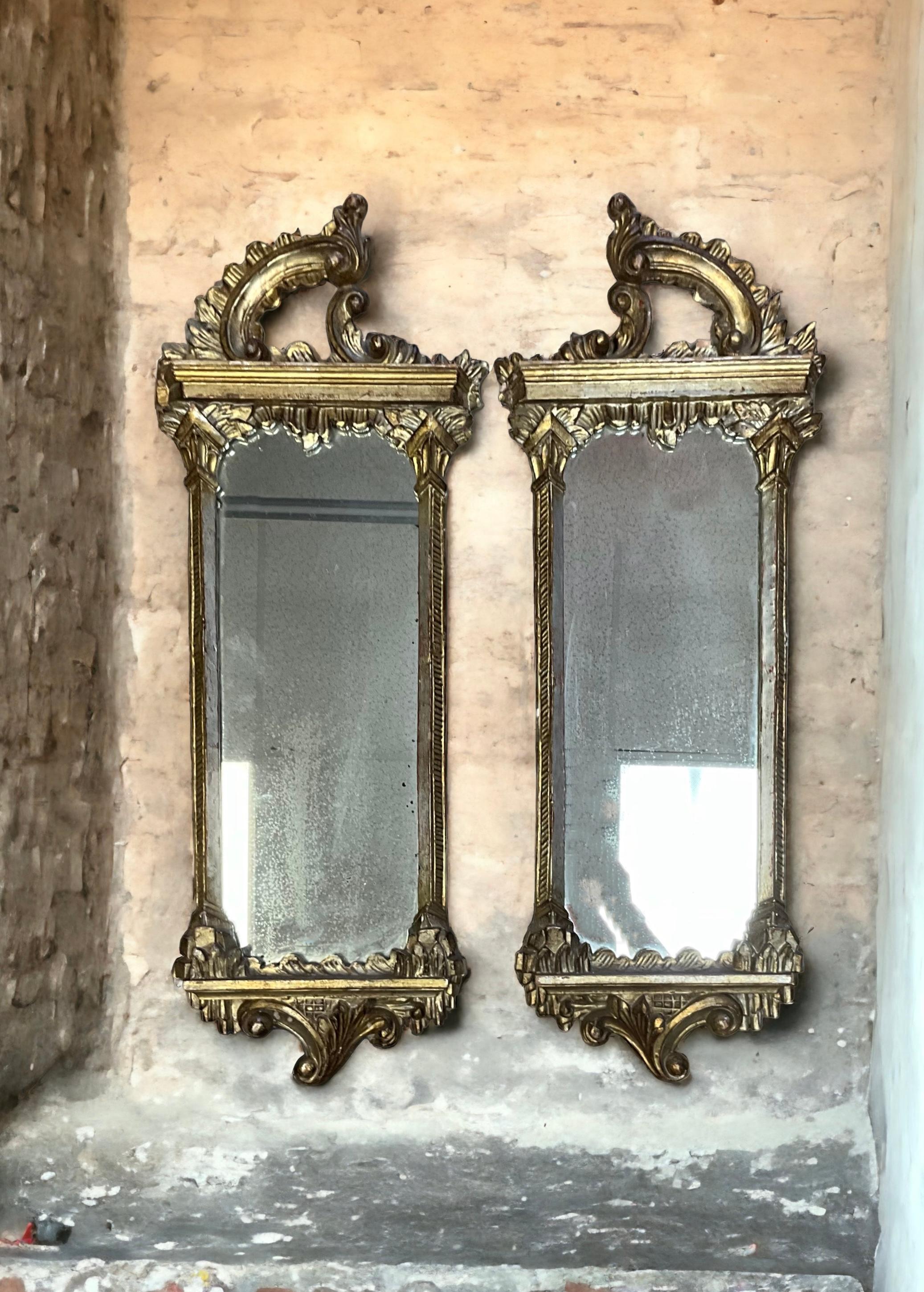 These are beautiful! It is a large scale 1930s Italian Chinese Chippendale style silver giltwood mirrors. They are in very good condition and are unmarked. The glass shows some age wear. Even though the mirrors are predominantly silver, they do have