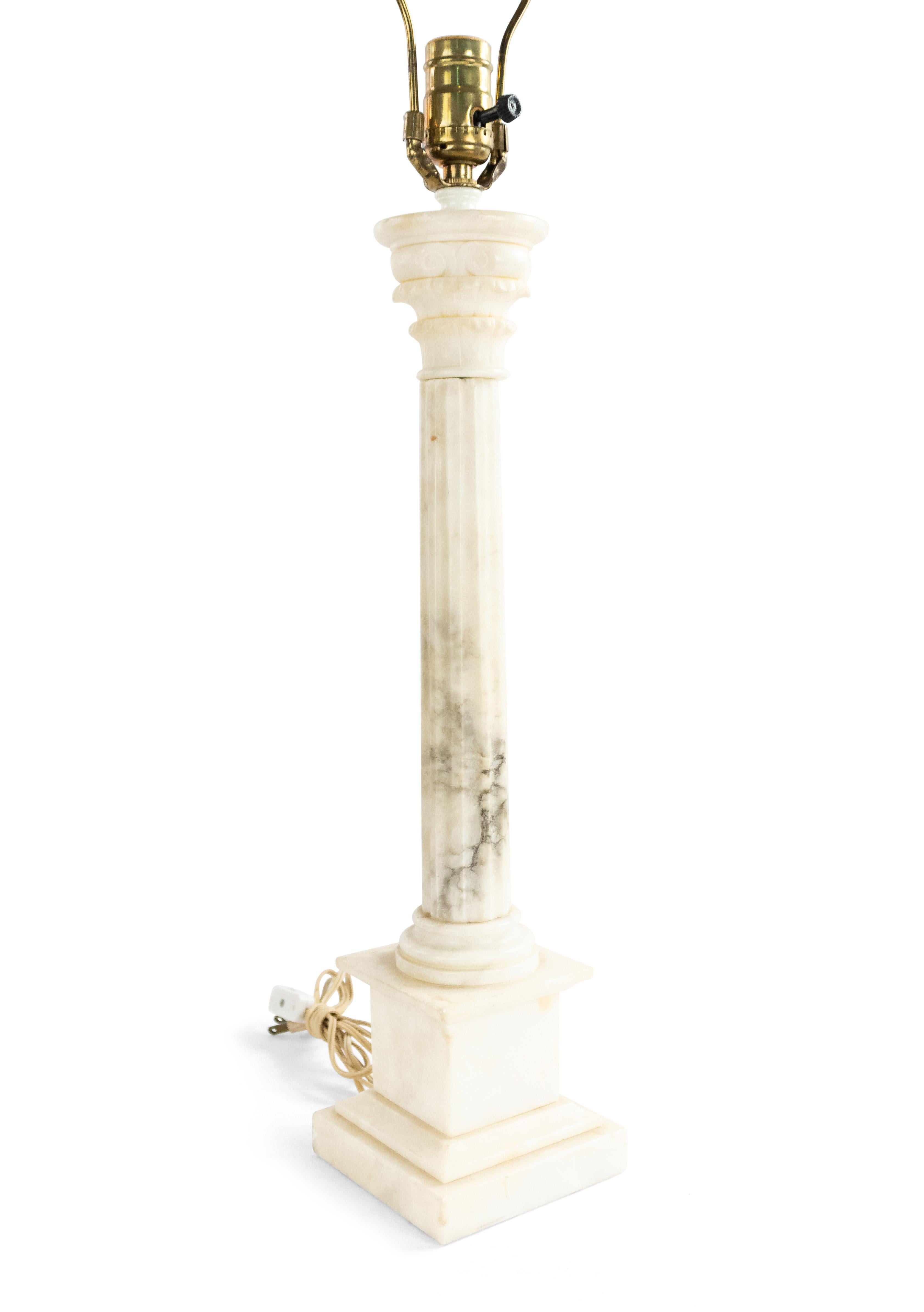 Italian Art Moderne (1930s) white alabaster table lamp with a fluted column on a square base with a carved corinthian capital and floral final.
