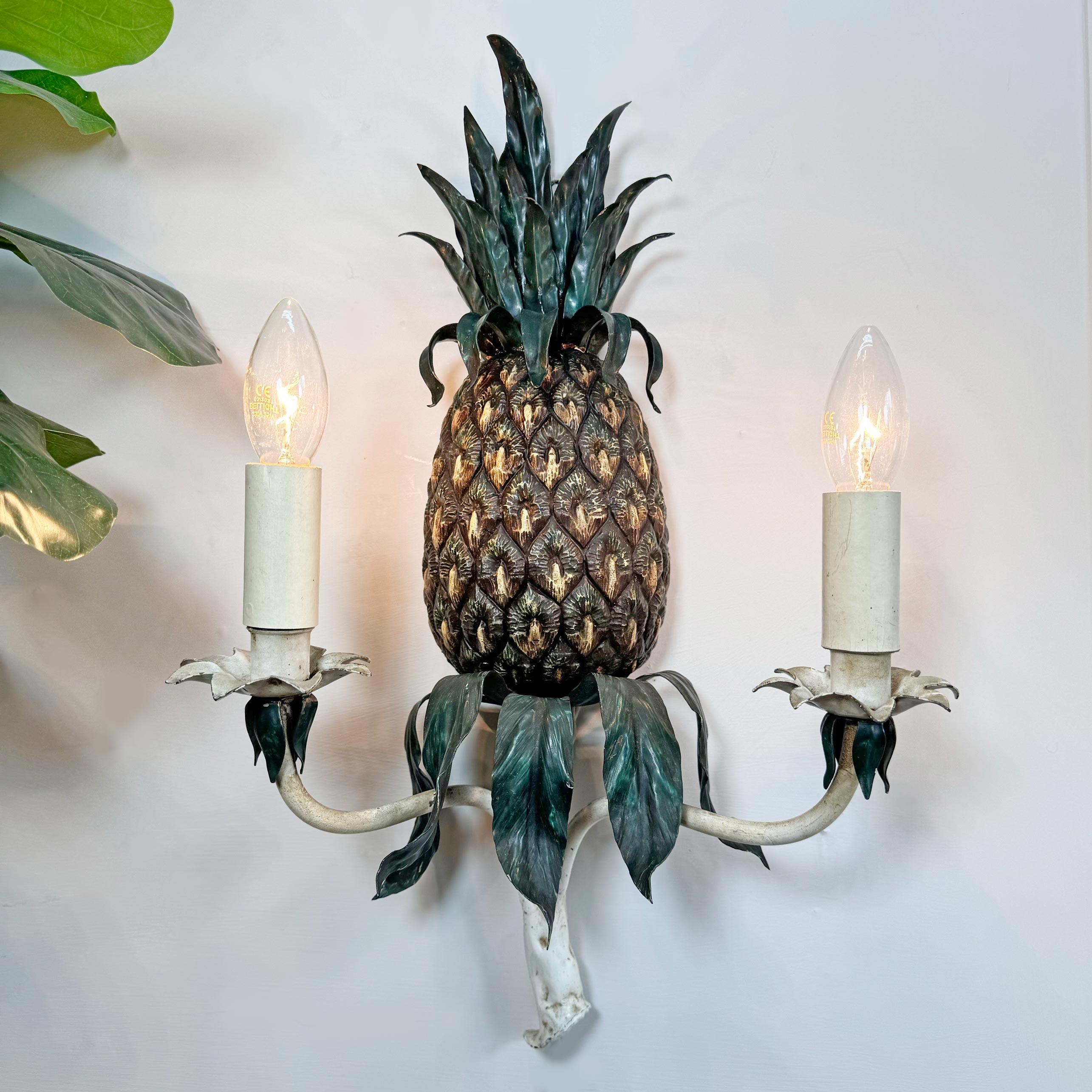 Exceptional quality polychrome painted iron wall light, formed as a pineapple, green fronds to the top and base, beautifully cast branches in white paint with two b14 (small bayonet) lamp holders.



Italian, circa 1930.



Height 54 cm, Width 34