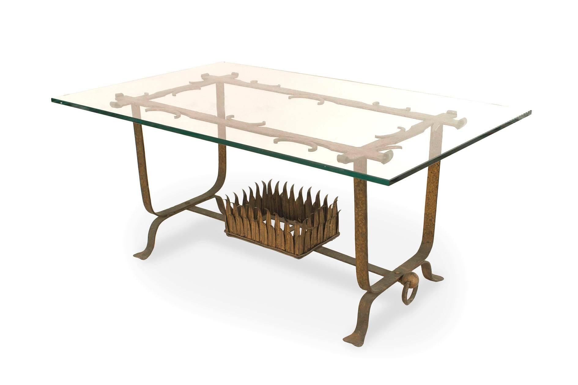 Italian Renaissance-style (1930s) gilt wrought iron coffee table with a rectangular beveled glass top supported on a base with ring sides, a stretcher, and a centered small shelf with a leaf border.
