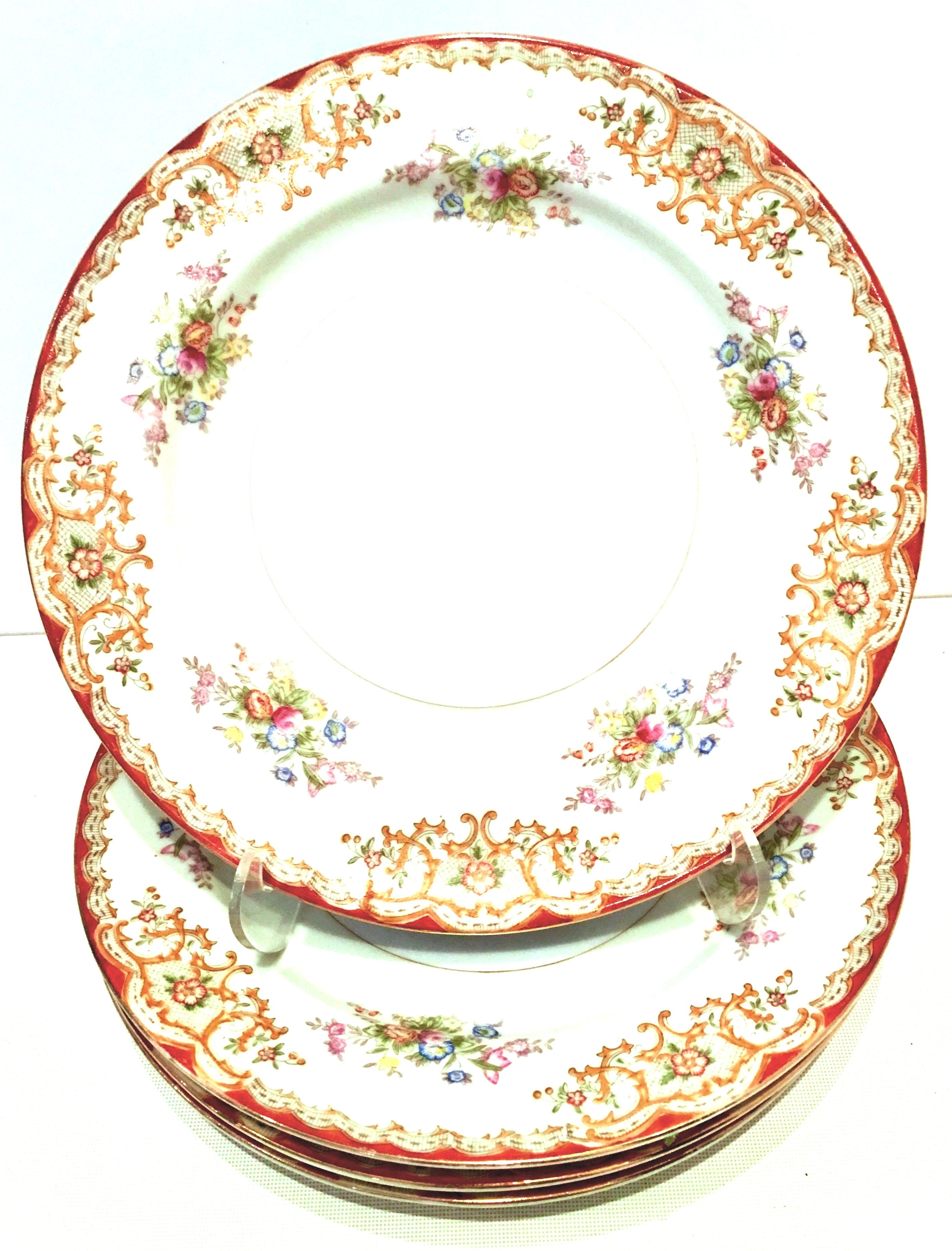 Art Nouveau Japanese hand-painted porcelain dinnerware, S/19 with 22-karat gold edge detail. Scroll and rose patter of off white ground with cream, orange, lavender, pink, yellow, and green floral and scroll details. Each piece is signed on the
