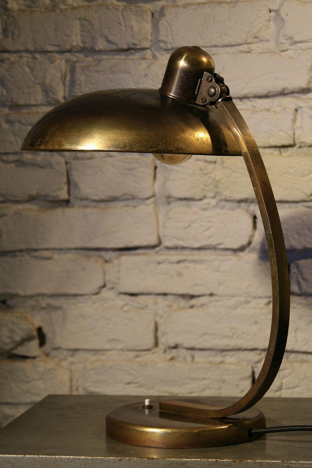 The original desk lamp produced in the 1930s by the German company Kaiser Idell.
Design: Christian Dell.
Construction:
The base, arm and lampshade made of brass, inside the base there is a massive cast iron lamp stabilizing element. In the upper