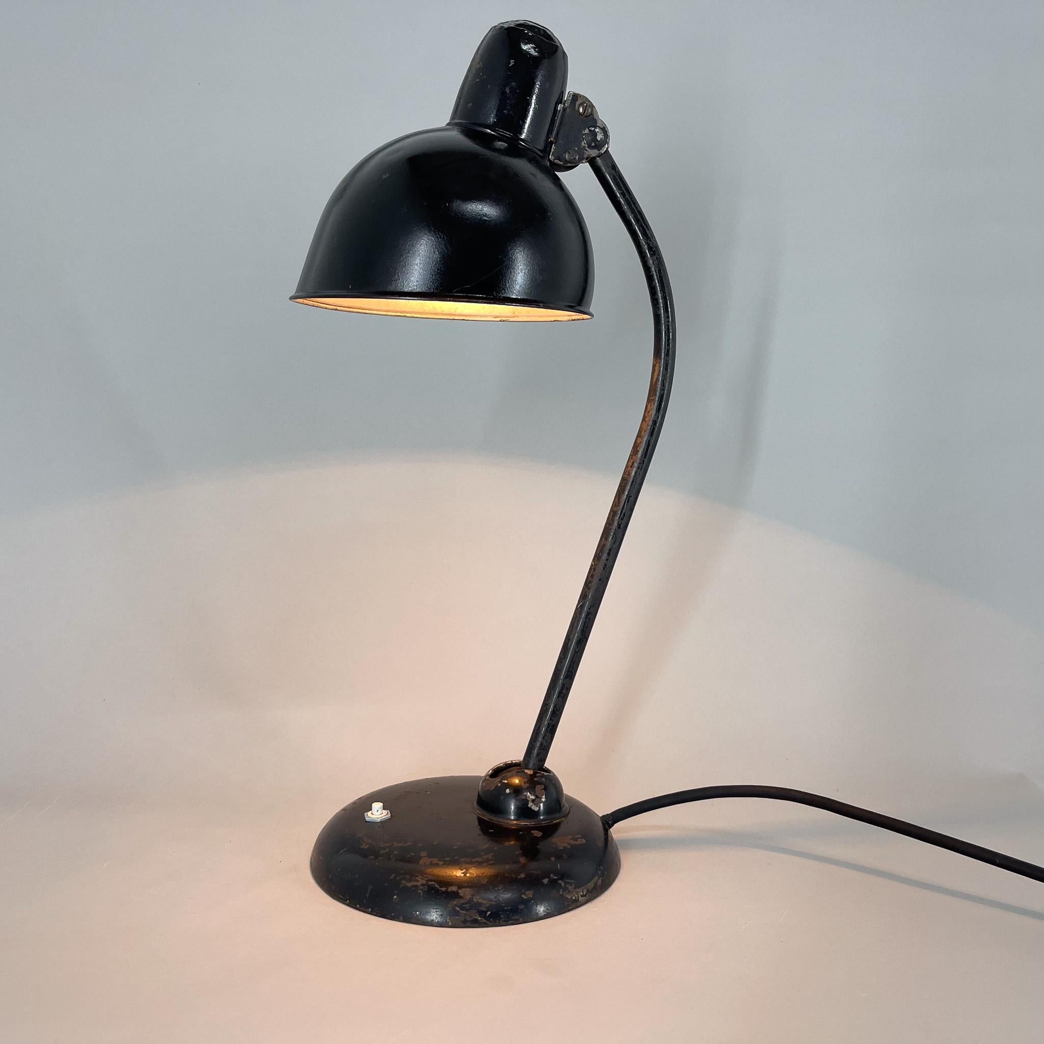 Vintage table metal table lamp with adjustable arm and shade, designed by Christian Dell for Kaiser. Bulb: 1 x E26-E27. US plug adapter included.
