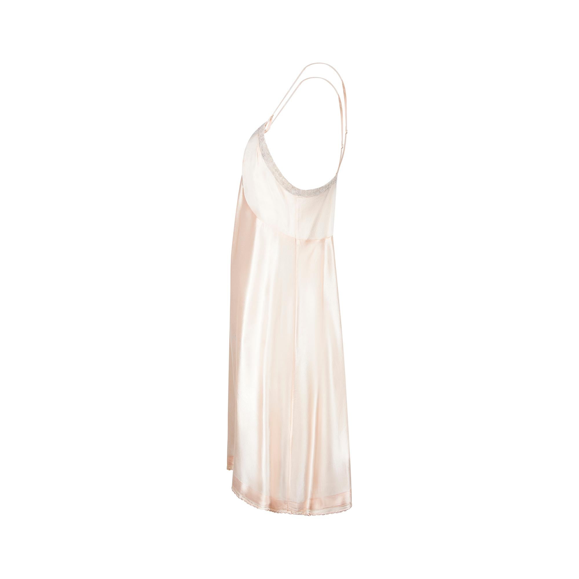 Slip dresses of the 1930s are highly collectable and this is a truly lovely example. They are prized for their wearability and the luxuriousness of the fabrics as well as the simple grace of their silhouettes. This slip is crafted from pale peachy