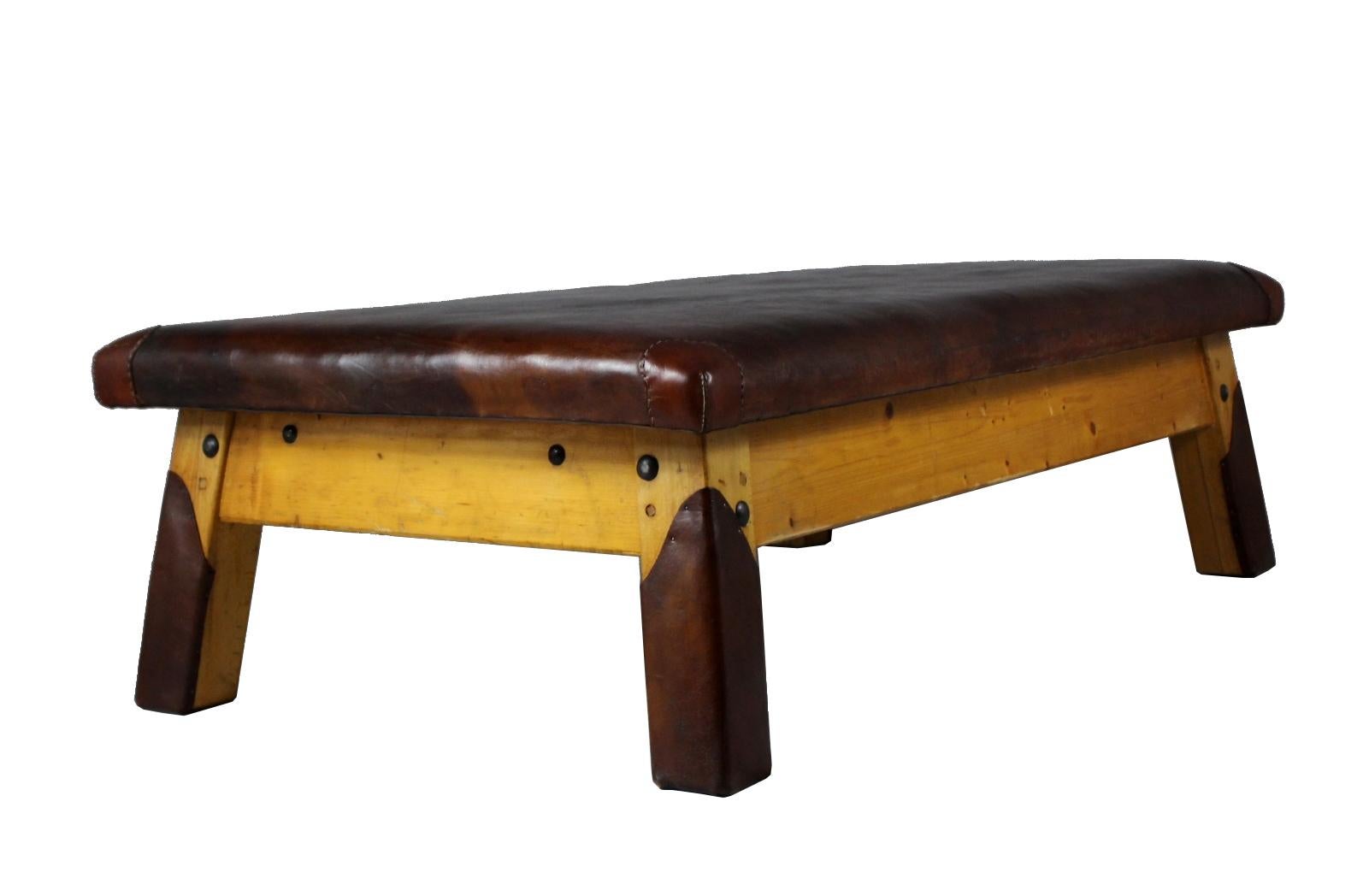 Large leather gym table/ daybed/ bench from the 1930s. The top is made from thick leather with nice patina, wooden legs. Very good condition.
