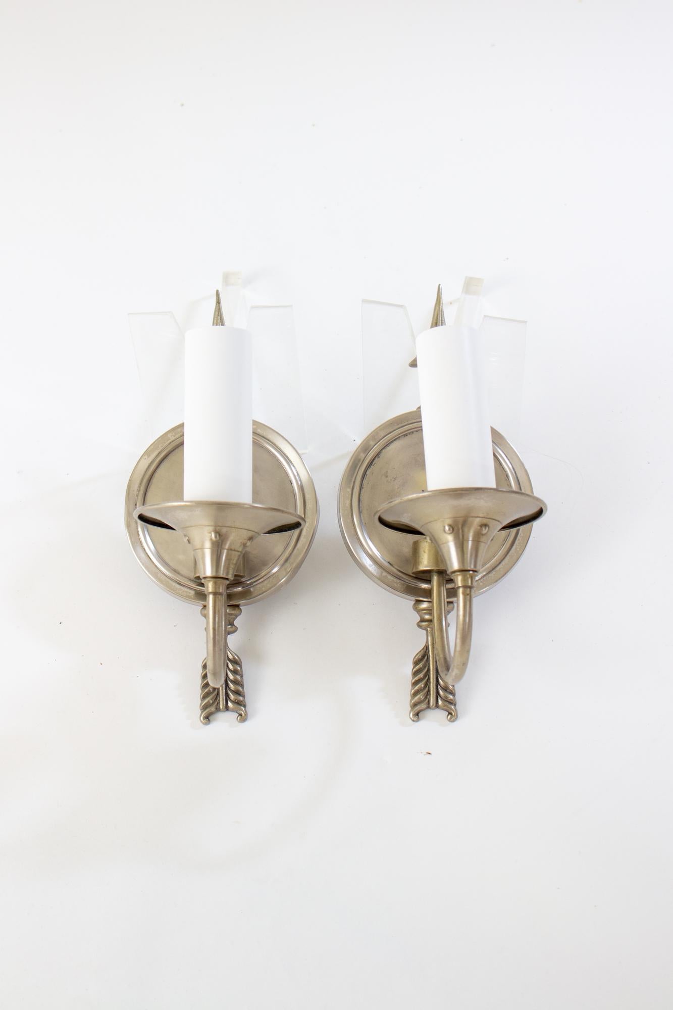 1940’s Levolite nickel arrow sconces with round backplates. Slender arm curves up to a single light. Marked “Levolite After Daylight” Brushed nickel finish in good condition, with some wear shown in center. Rewired, US110-120V hardwired. Ready for