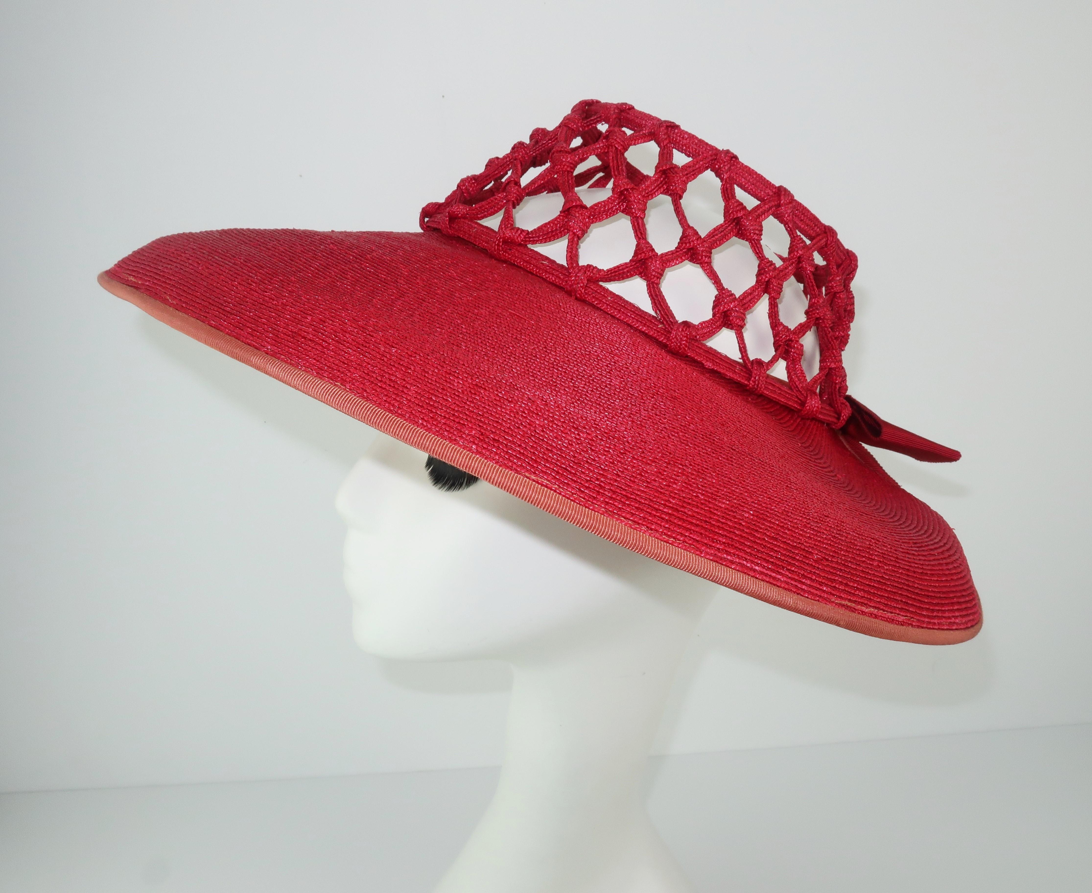 Uber chic 1930's lipstick red straw hat with a unique lattice patterned cage crown providing visual interest and practical ventilation.  The wide brimmed silhouette nips in at the back with a red grosgrain ribbon accent.  A wonderful topper for