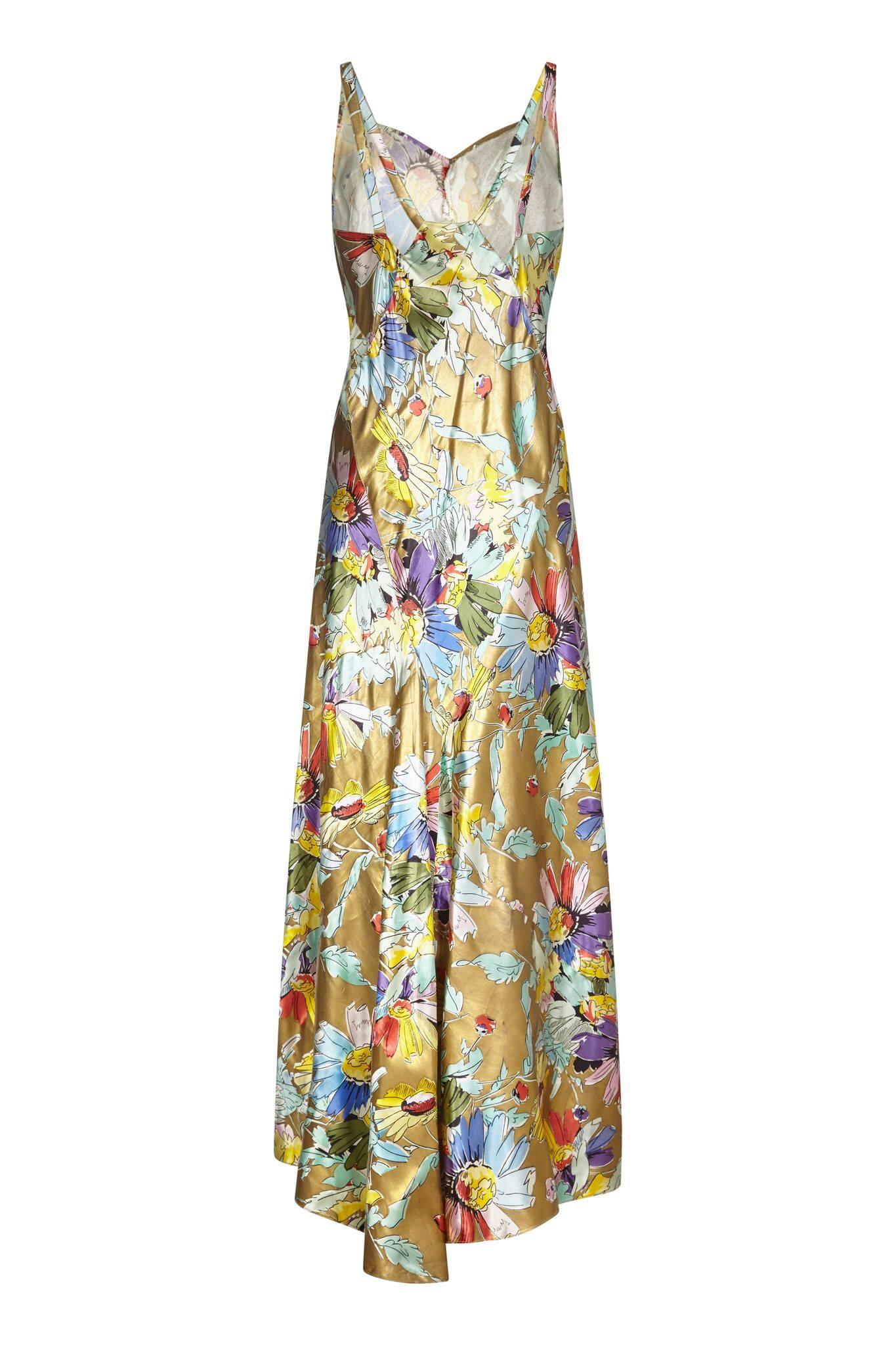 This sensational liquid gold satin bias cut dress; an original vintage 1930s piece, is one of the best we have ever seen.  The floral art deco print is striking with an array of colours of the rainbow and subtle, paler pinks, blues, sea-foam and