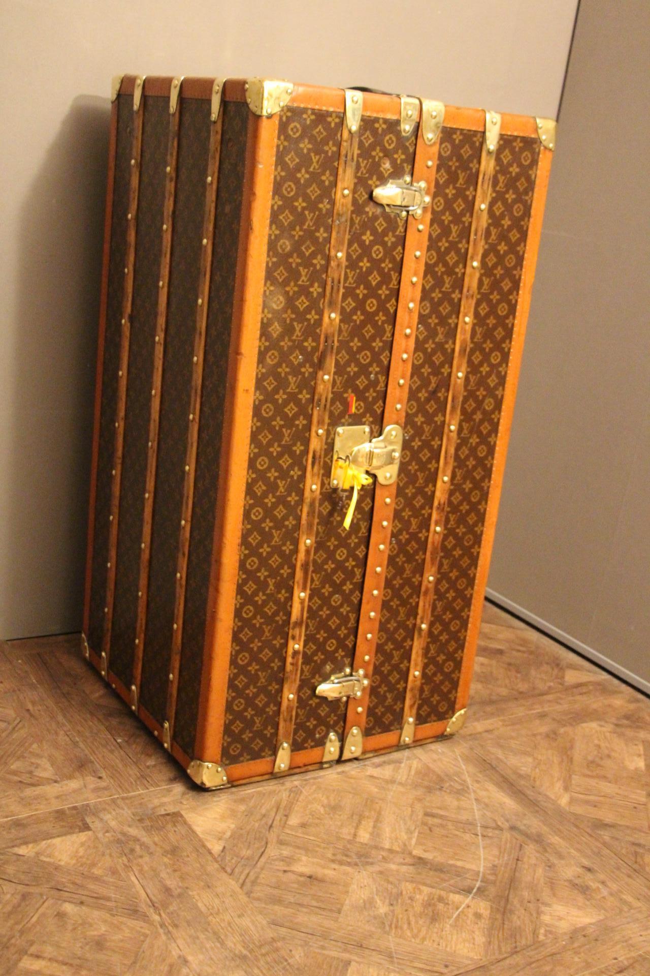 This beautiful wardrobe steamer trunk from Louis Vuitton features stencilled monogram canvas, leather top handle, solid LV engraved brass locks, solid brass corners and all LV stamped studs. All original leather handles. Very warm patina.
Locking