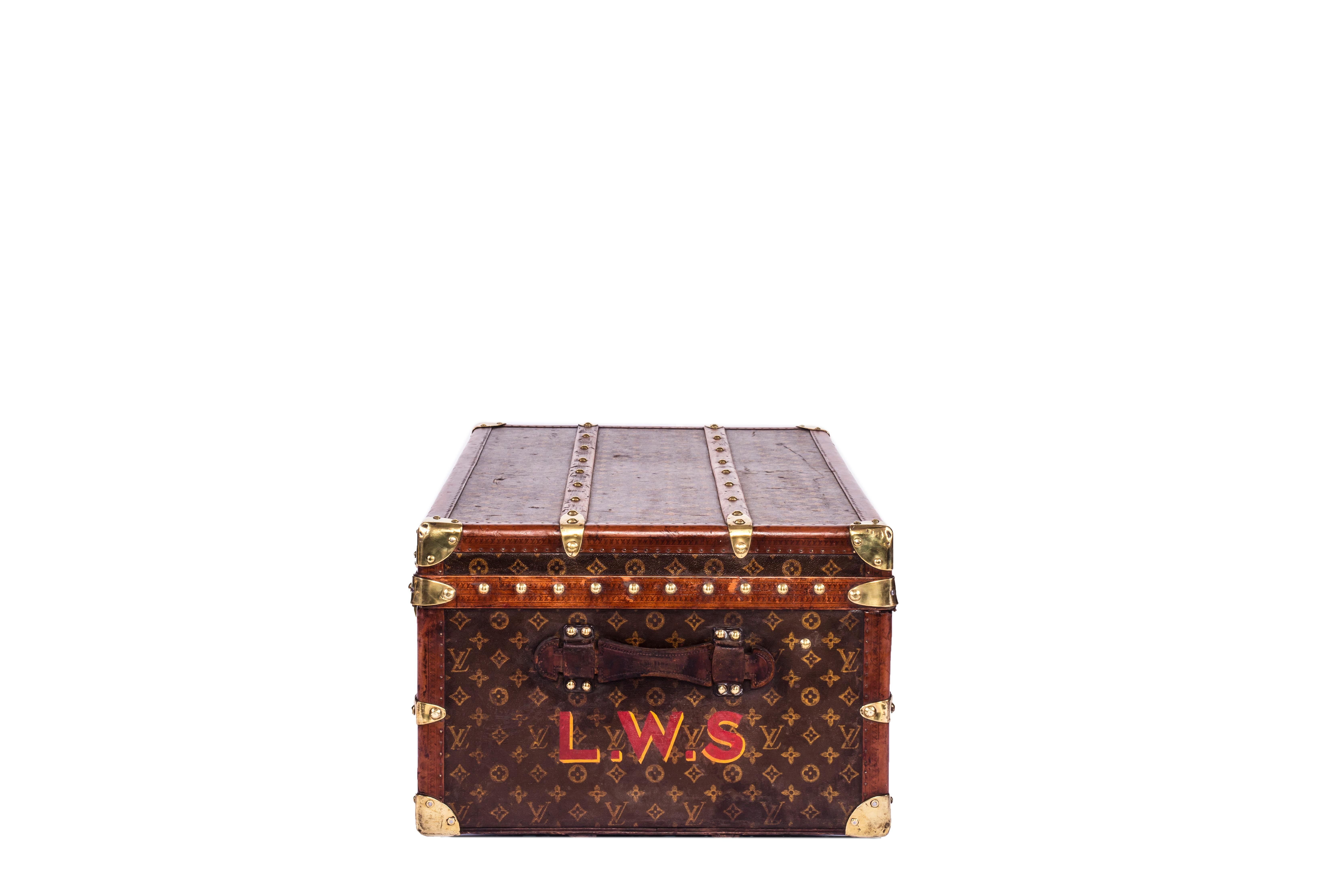 A beautiful cabin trunk that is entirely covered signature stencil monogrammed canvas from Louis Vuitton circa 1930s. 

It features:
- Lozine trim, 
- Wooden slats 
- Brass hardware. 

Original owner’s initials are painted on the side