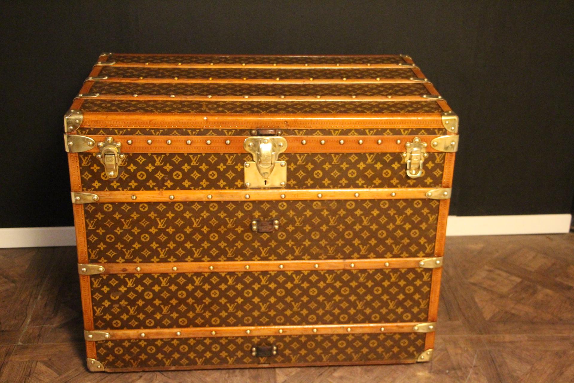 This superb Louis Vuitton steamer trunk features stenciled monogram canvas,honey color lozine trim, LV stamped solid brass locks and studs as well as leather side handles and brass corners. Its customized painted white and blue flag adds a touch of