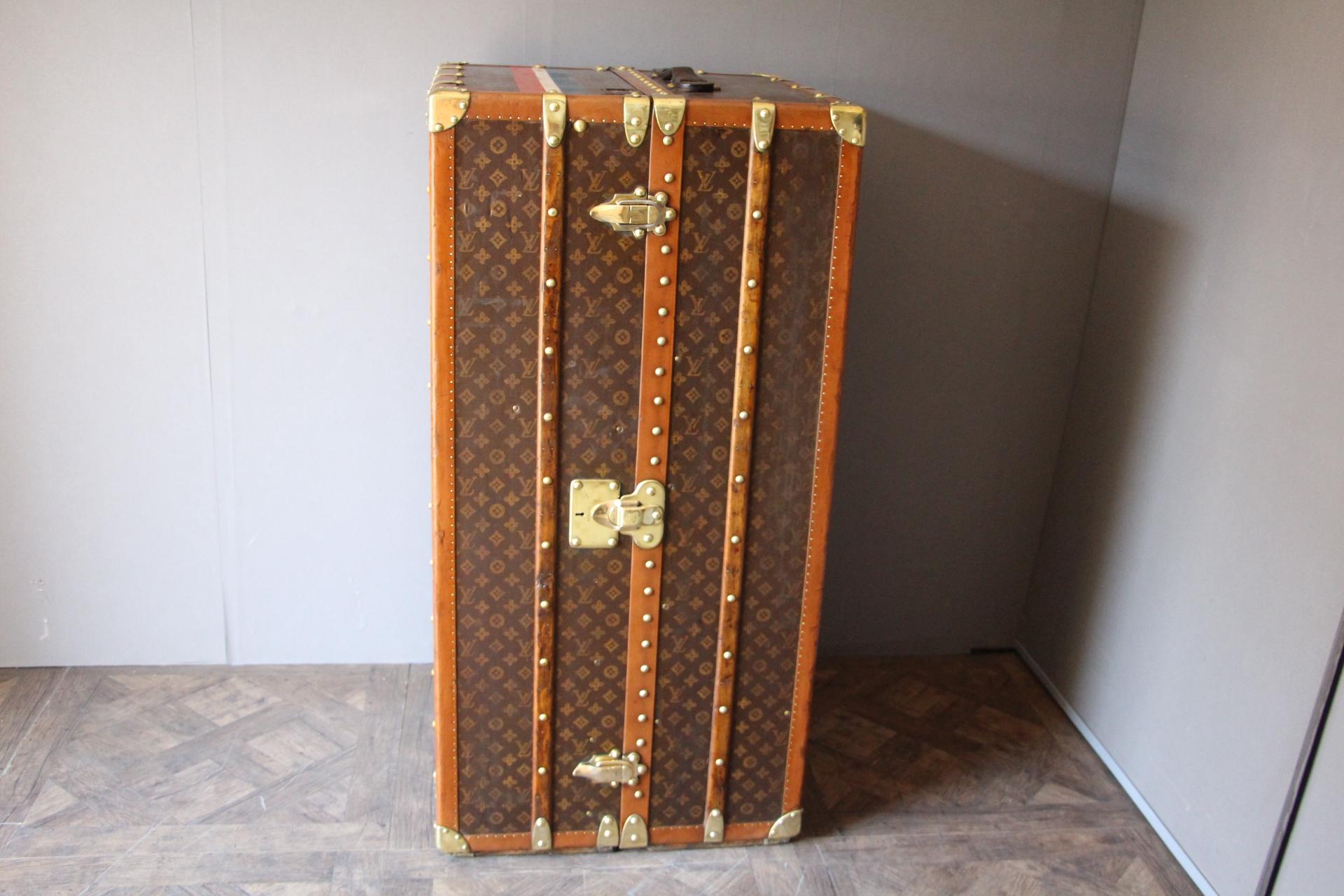 This impressive Louis Vuitton wardrobe features stenciled monogram canvas, lozine trims and solid brass locks.
Locks and studs are all marked Louis Vuitton. Customised painted stibes on the top.
Its interior is complete with a lot of original