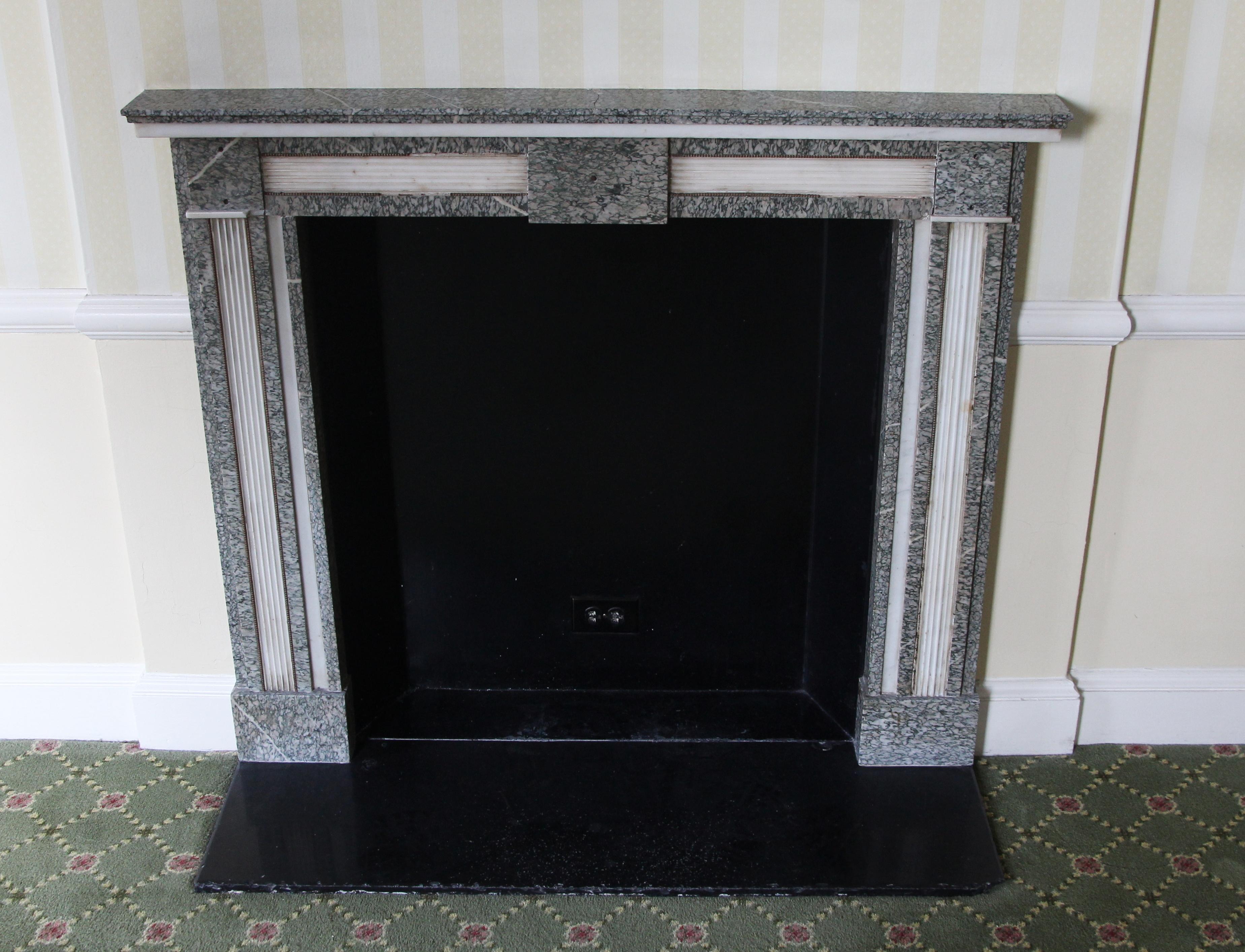 Hearth not included. Louis XV style gray and white marble mantel. This mantel was one of a group of antique mantels imported from Europe and installed in the Waldorf Astoria hotel in the 1930s when the hotel was first built on Park Avenue. This